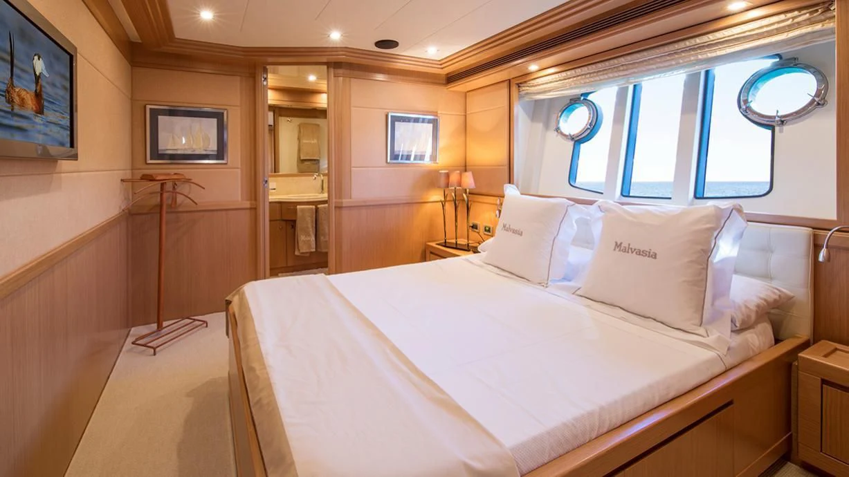 a bed with white sheets aboard EOLIA Yacht for Sale