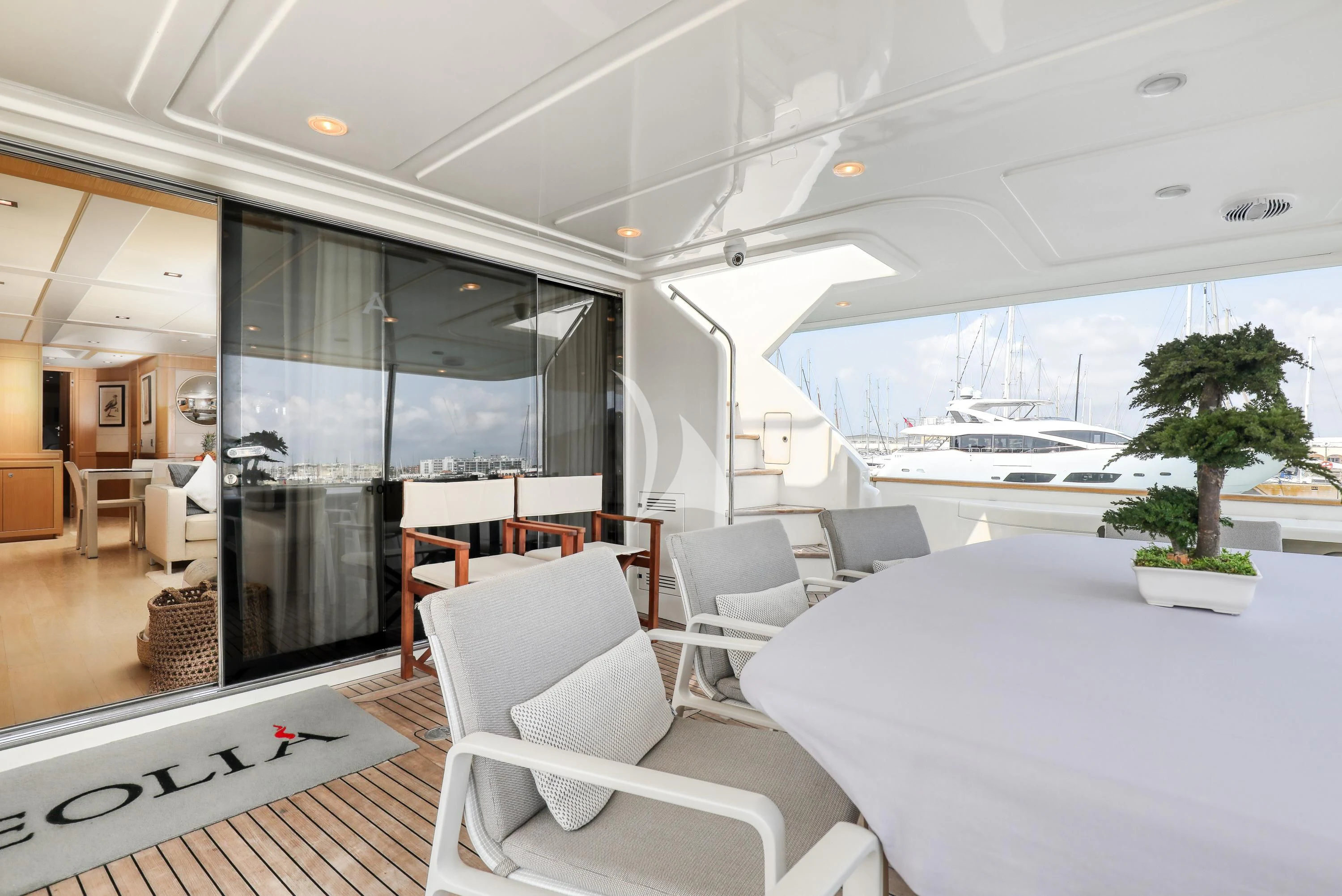 a room with a table chairs and a large window aboard EOLIA Yacht for Sale