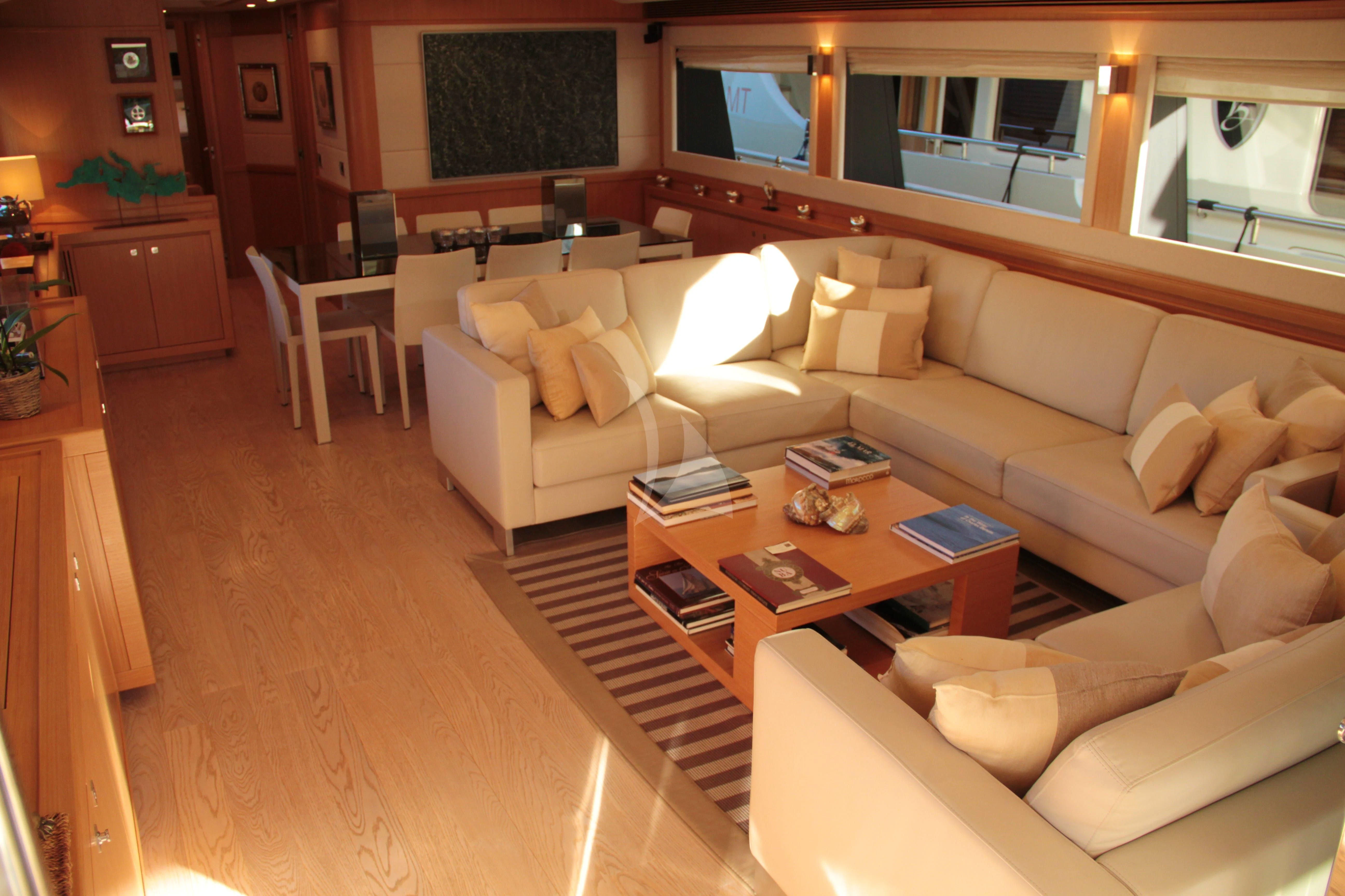 a living room with a couch and a coffee table aboard EOLIA Yacht for Sale