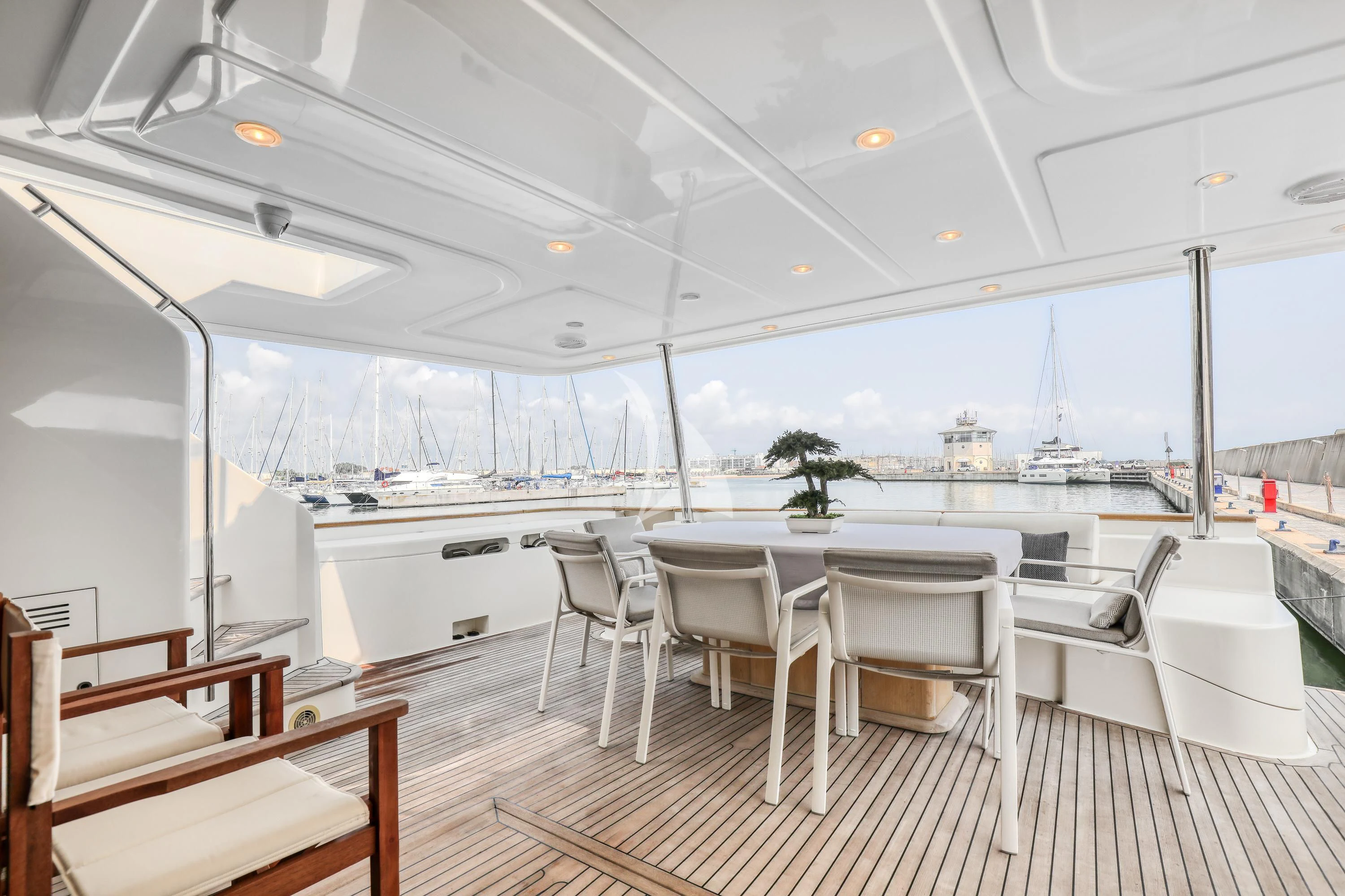 a room with a table chairs and a view of the water aboard EOLIA Yacht for Sale