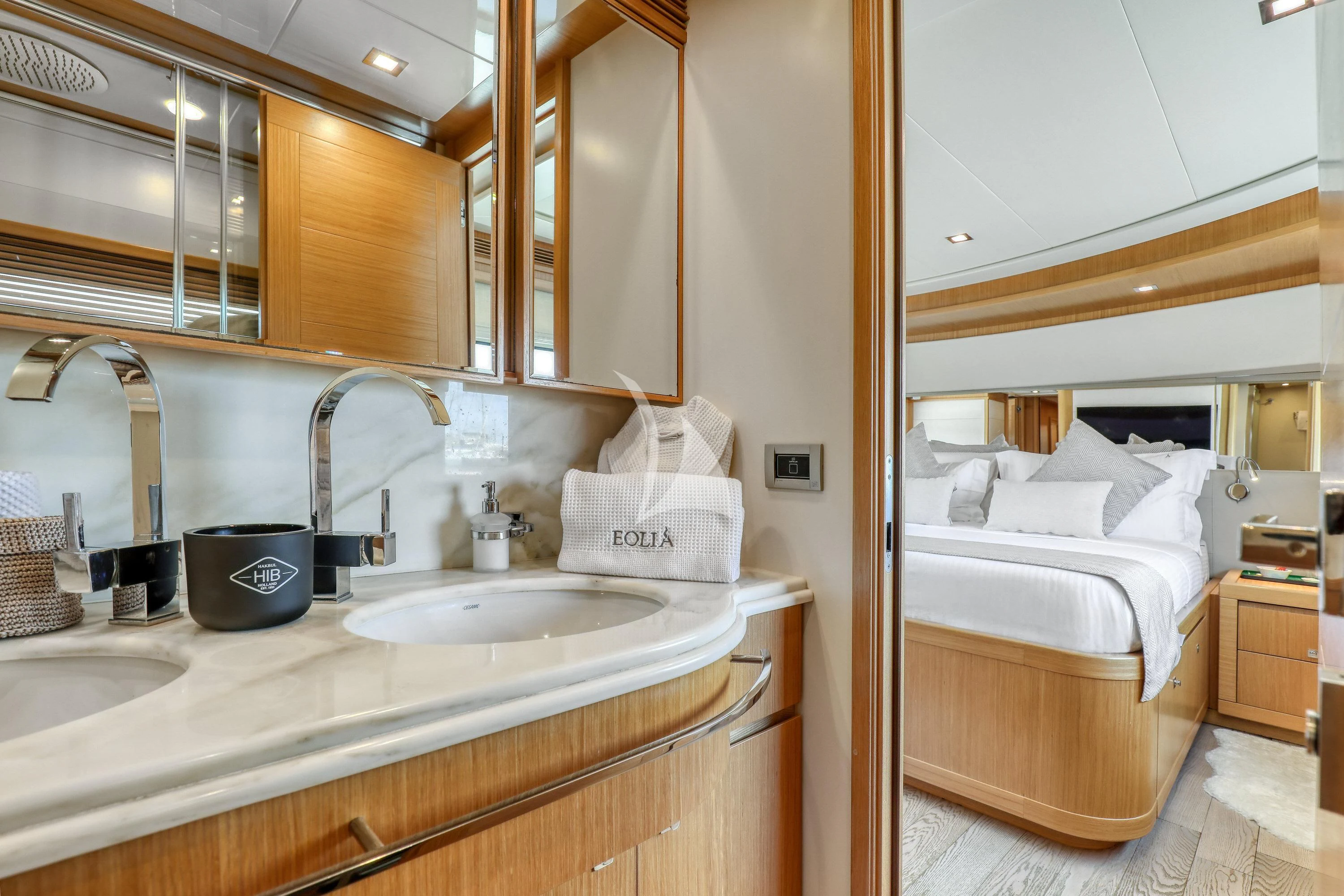a bathroom with a sink and a bed aboard EOLIA Yacht for Sale