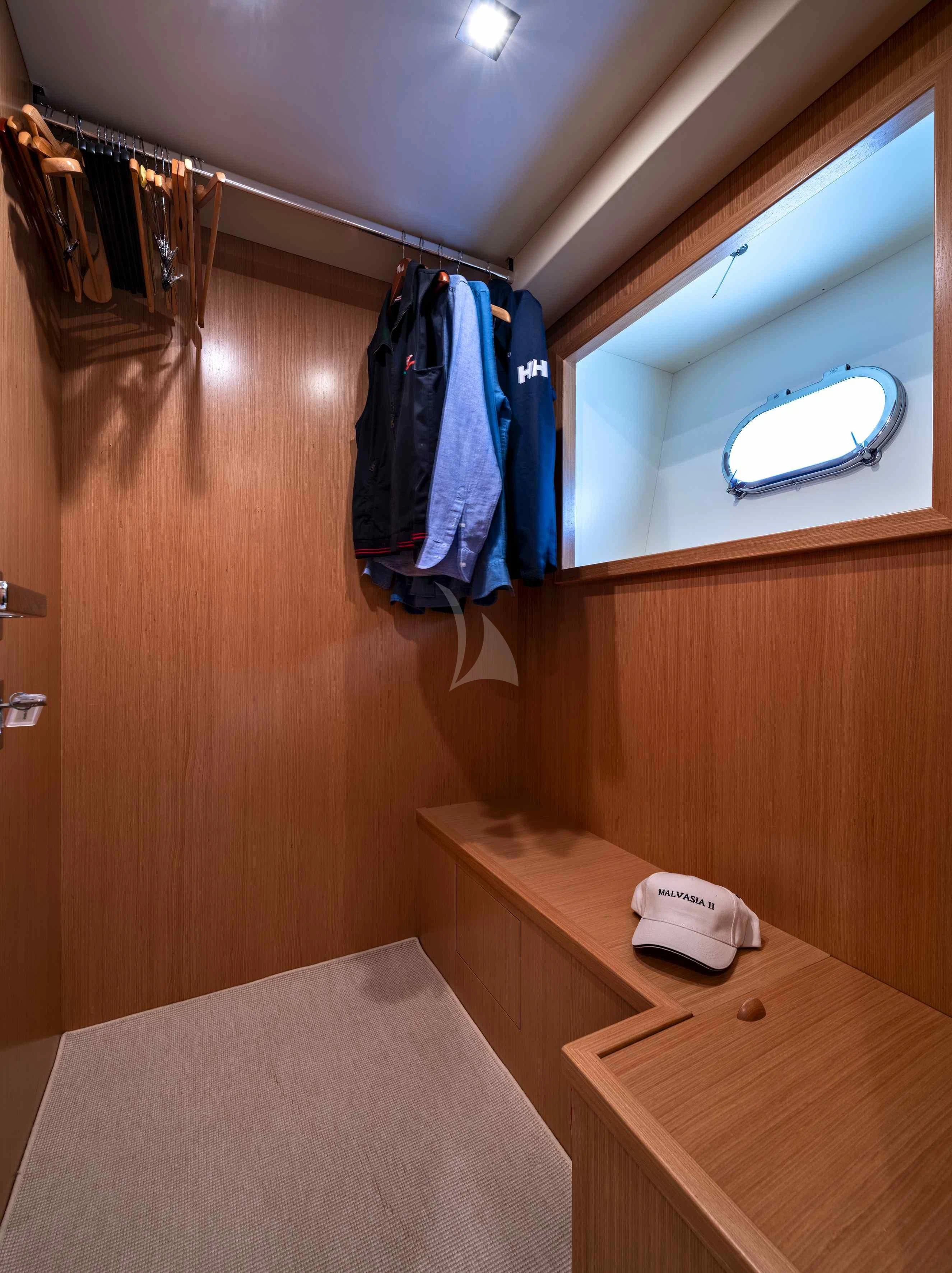 a closet with clothes on the wall aboard EOLIA Yacht for Sale