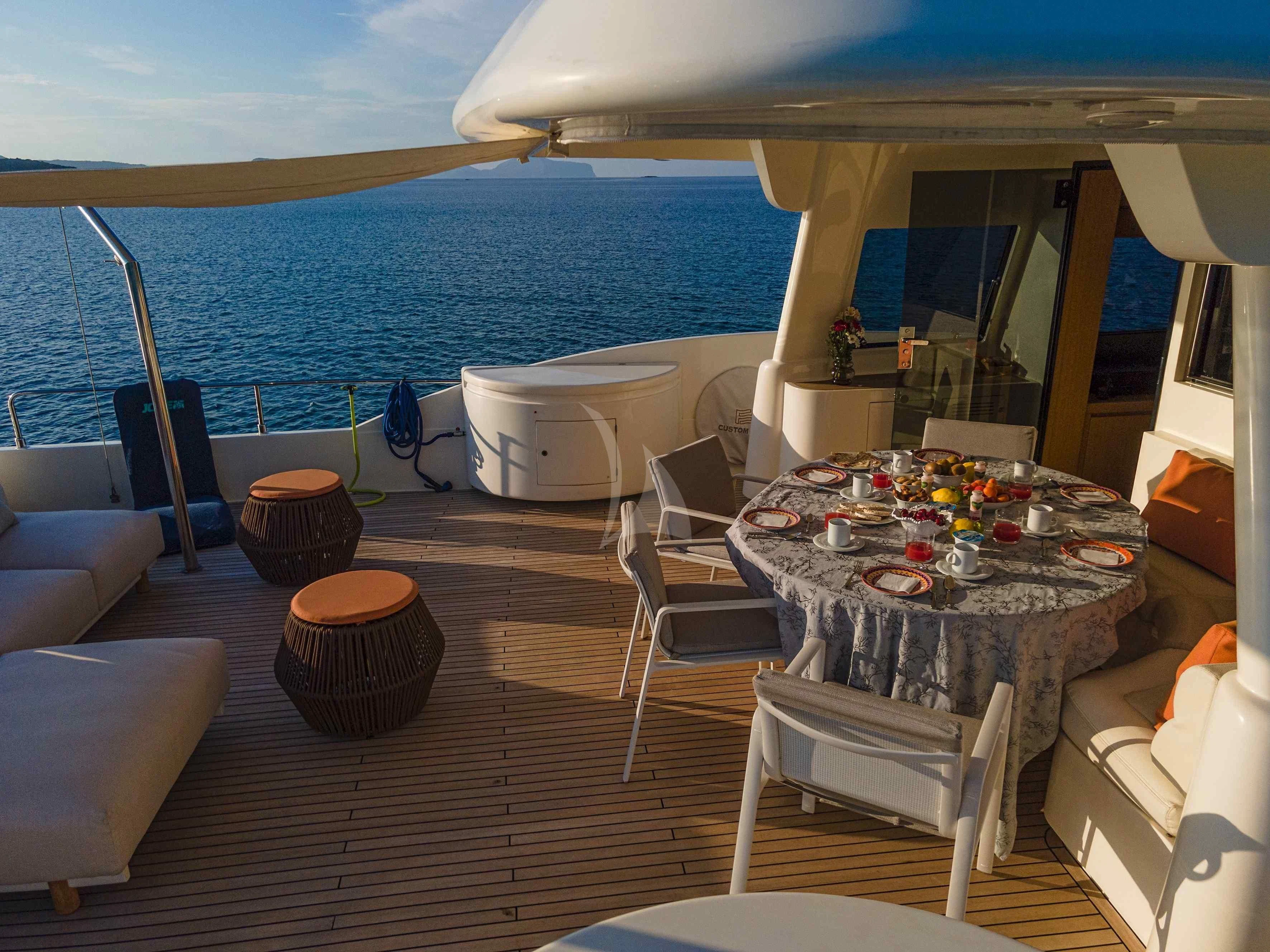 a room with a table and chairs aboard EOLIA Yacht for Sale