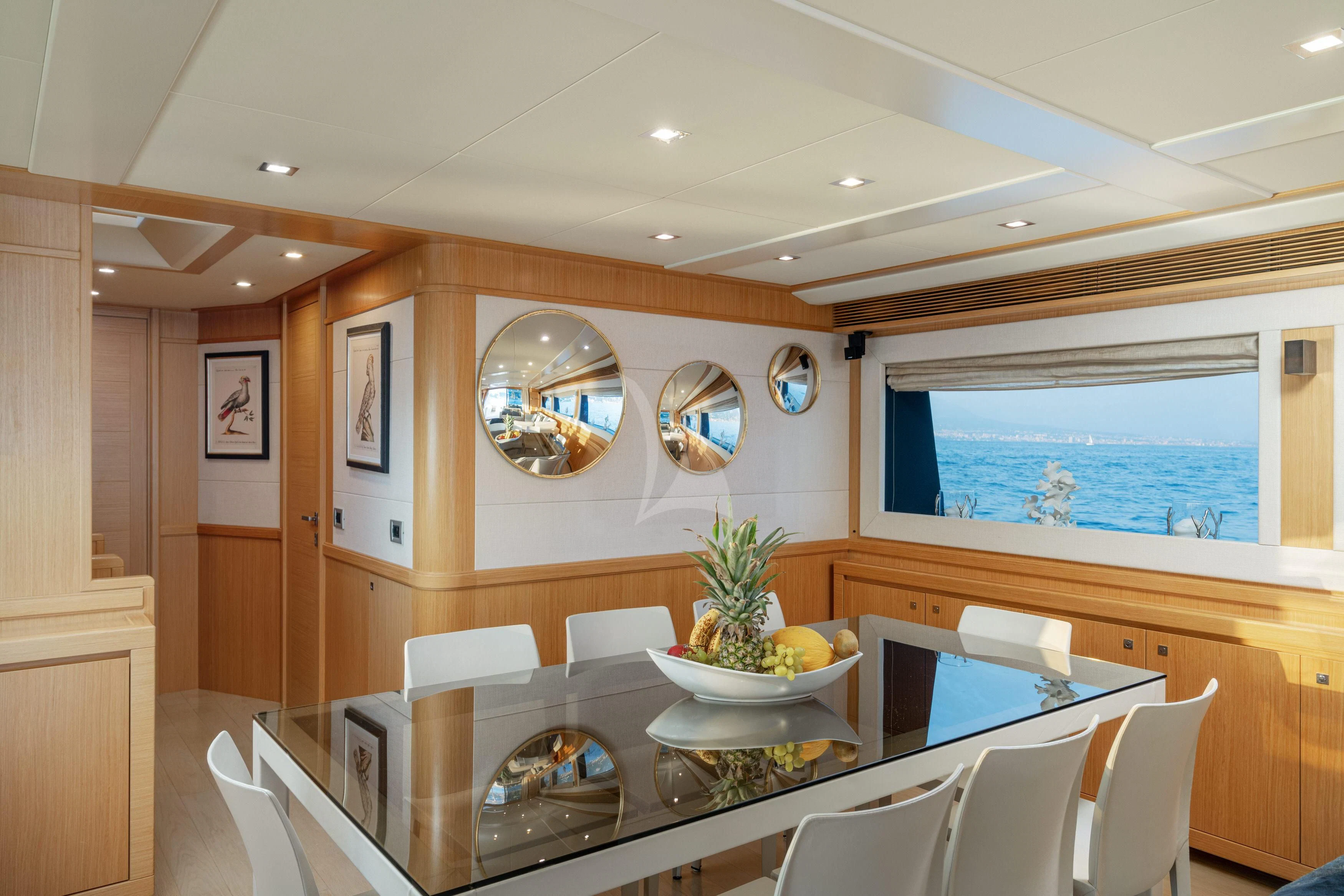 a large room with a table and chairs aboard EOLIA Yacht for Sale