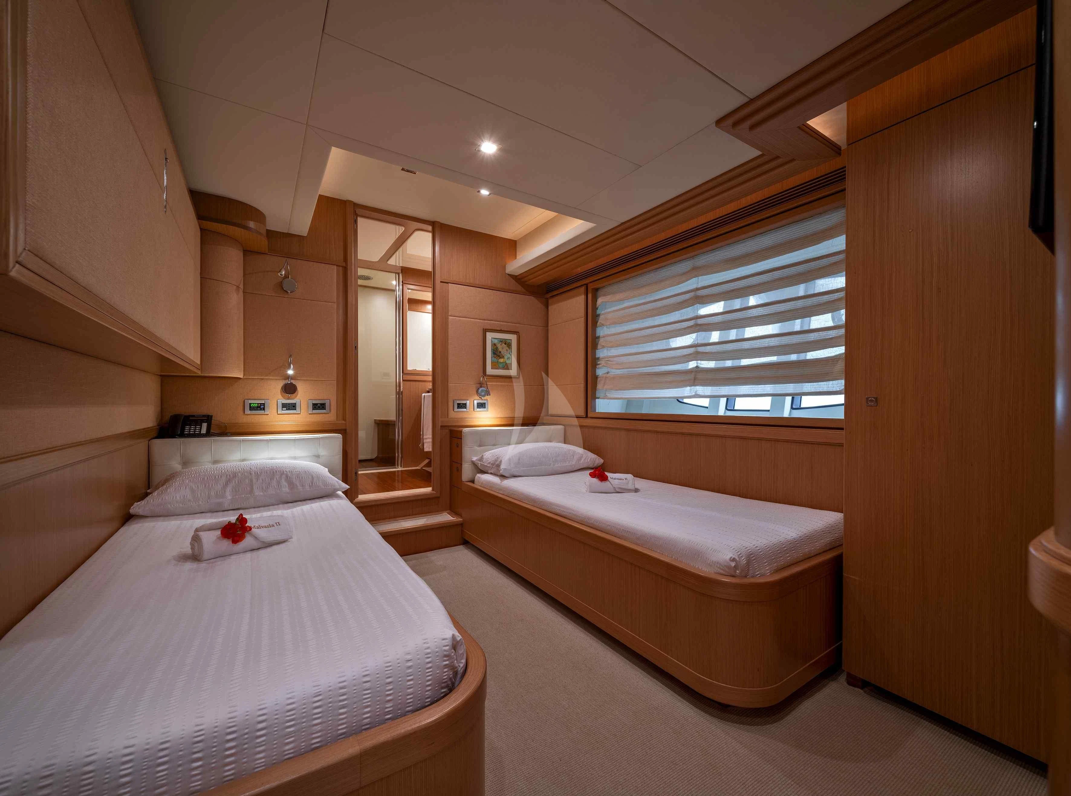 a room with a bed and a window aboard EOLIA Yacht for Sale