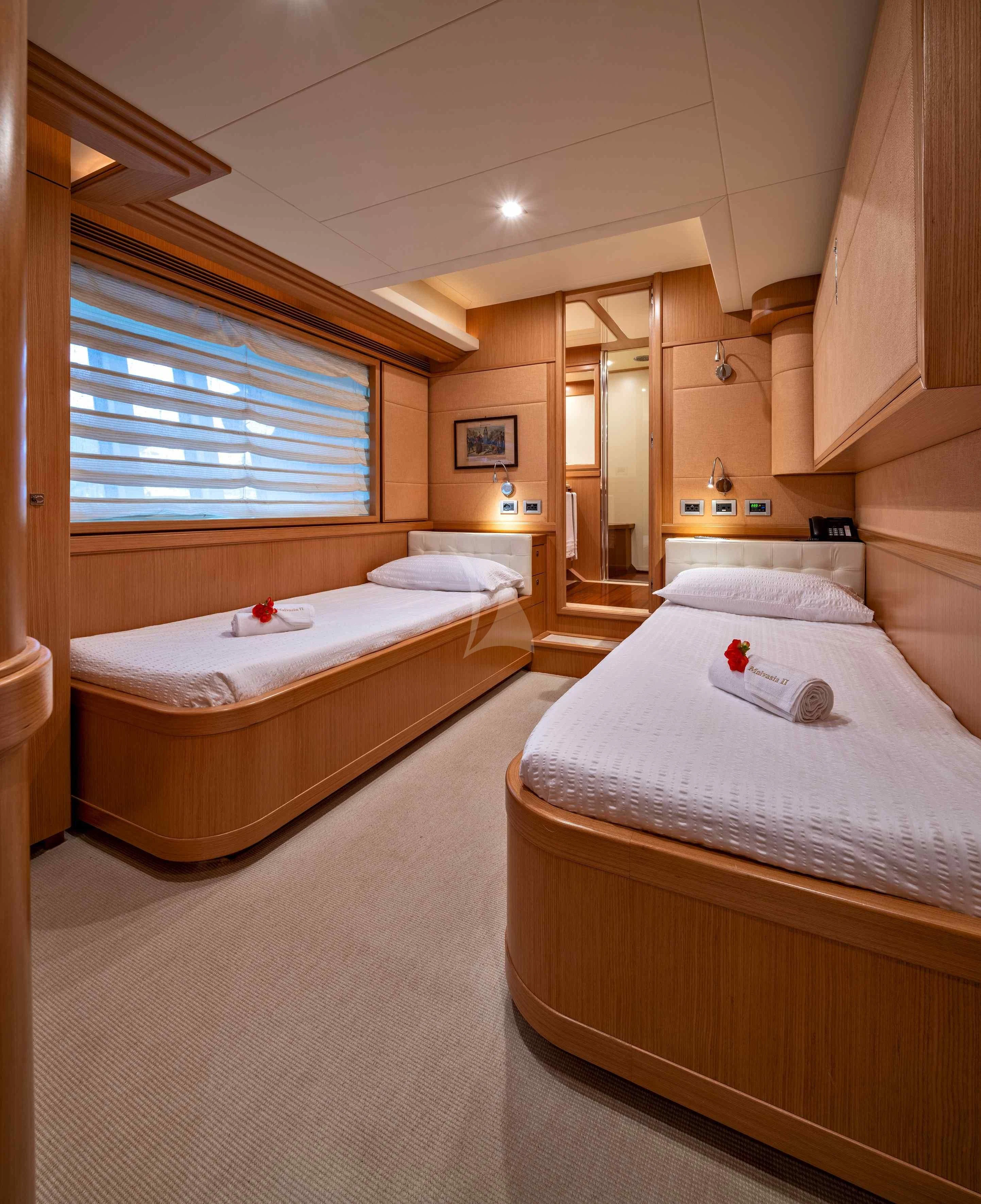 a couple of beds in a hotel room aboard EOLIA Yacht for Sale