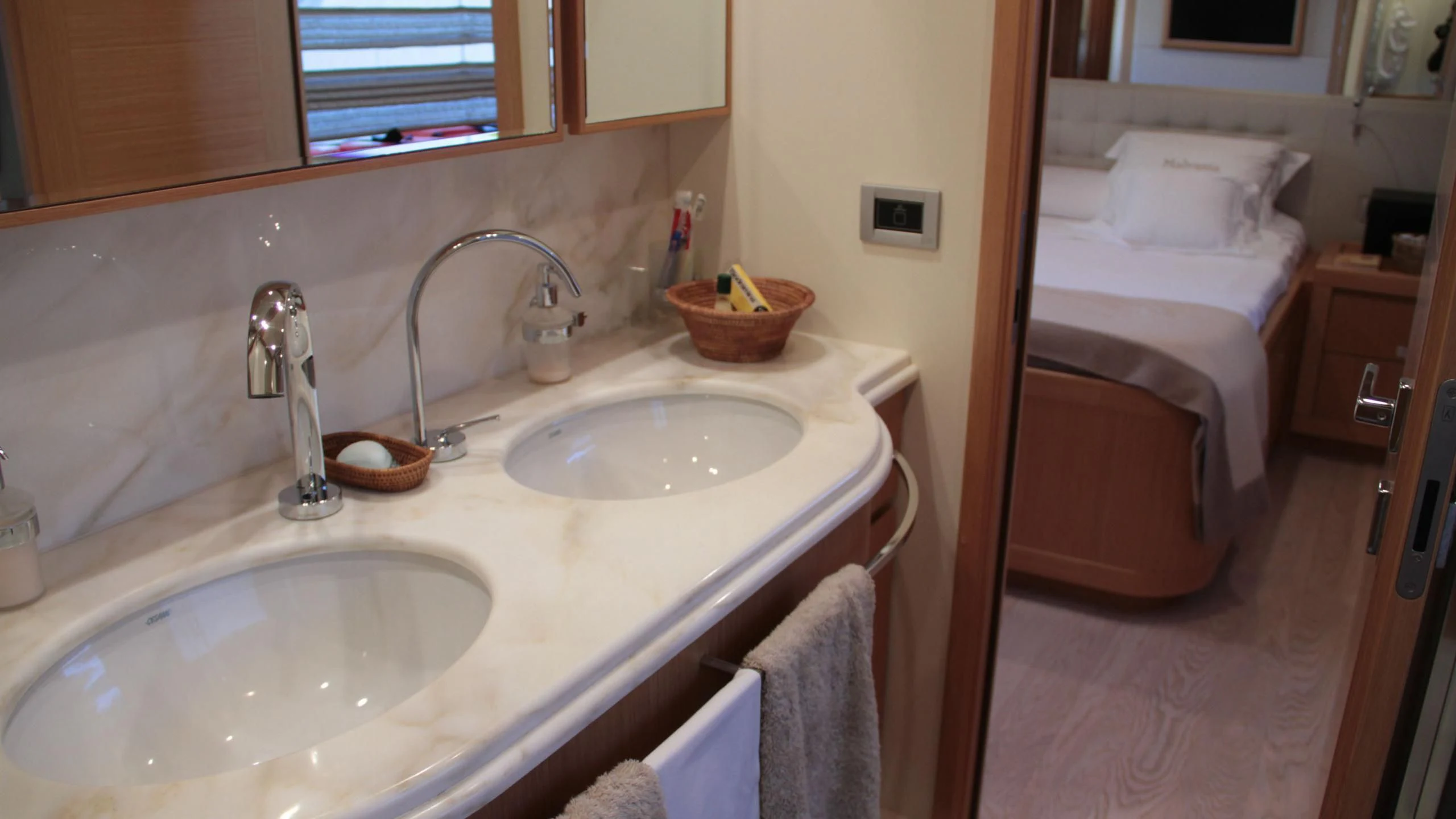 a bathroom with a sink and a bed aboard EOLIA Yacht for Sale