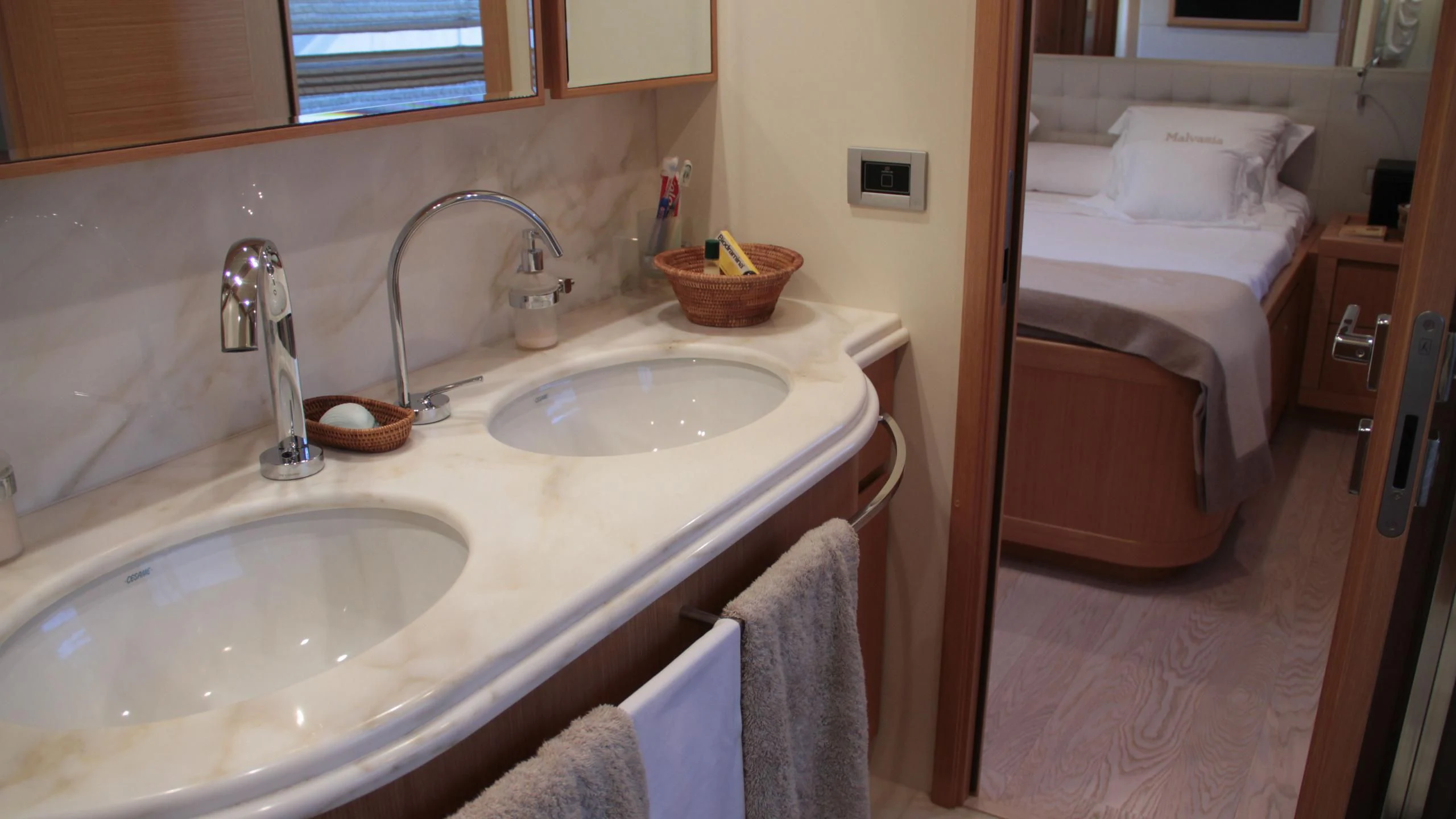 a bathroom with a sink and a bed aboard EOLIA Yacht for Sale