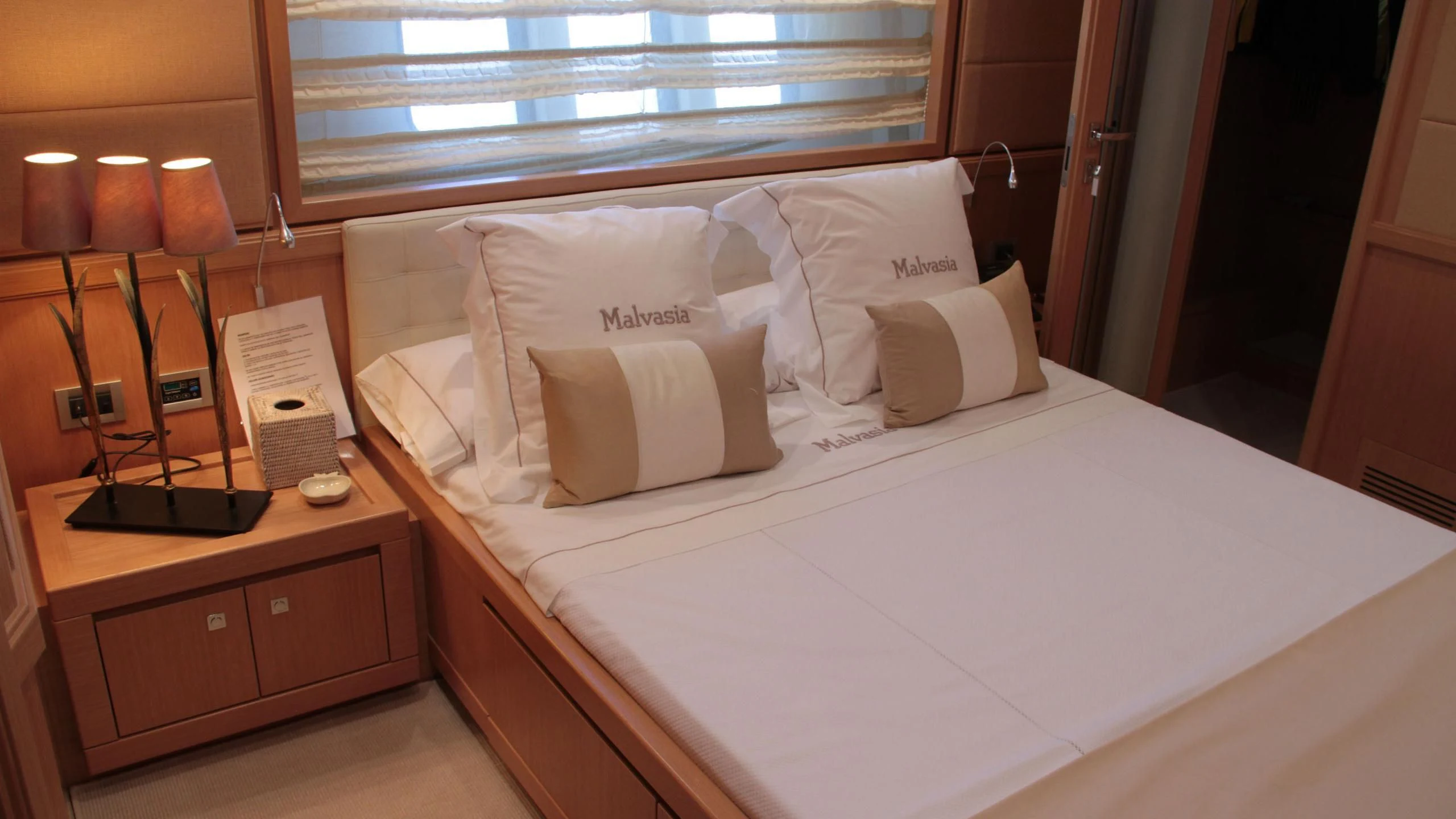 a bed with white pillows aboard EOLIA Yacht for Sale