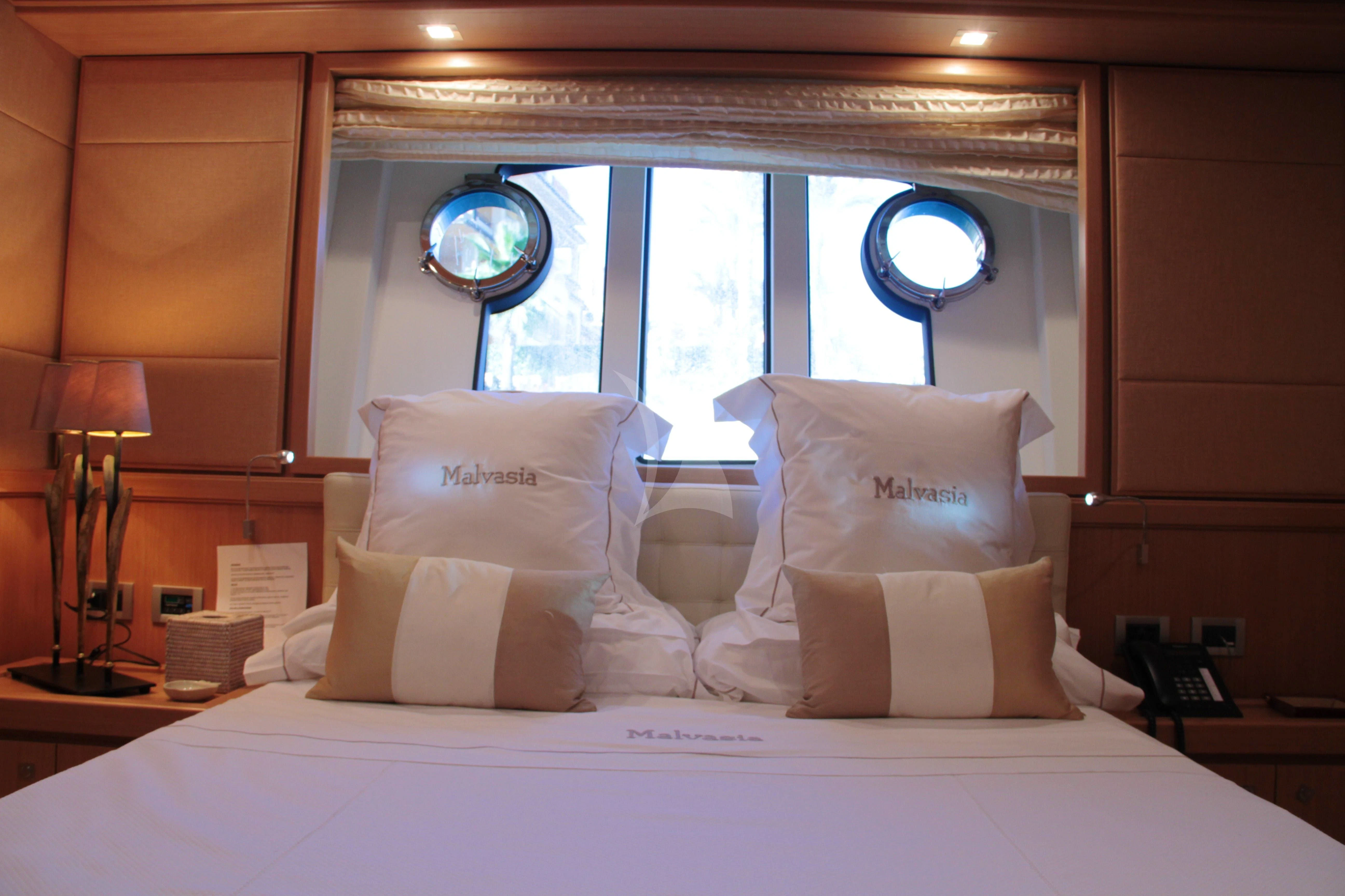 a bed with pillows and a mirror aboard EOLIA Yacht for Sale