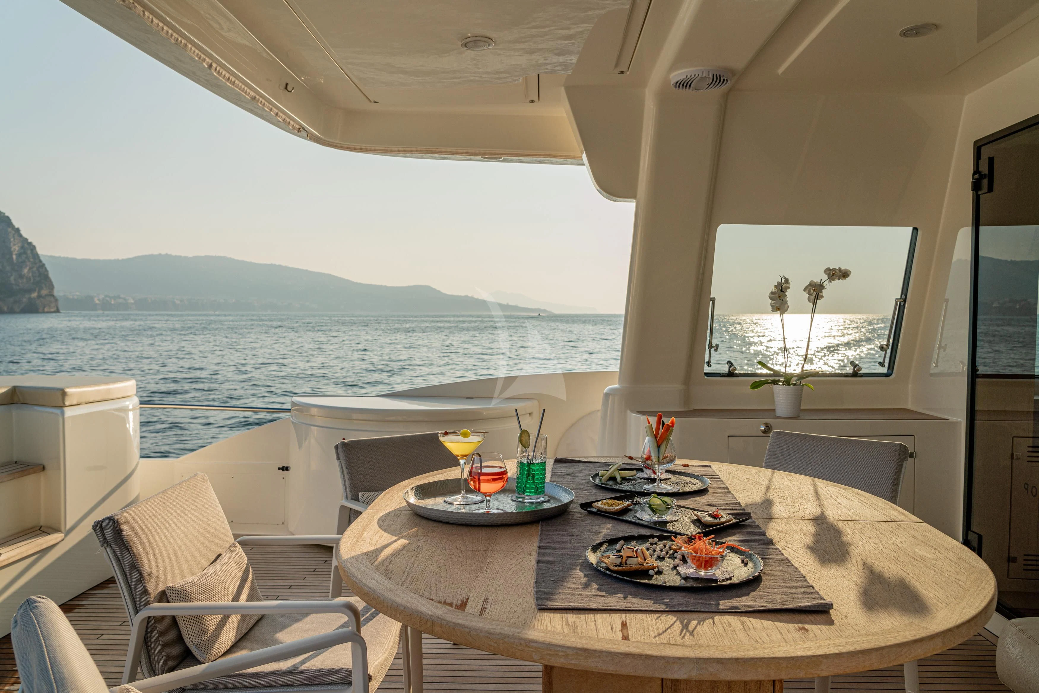 a table with plates of food on it aboard EOLIA Yacht for Sale