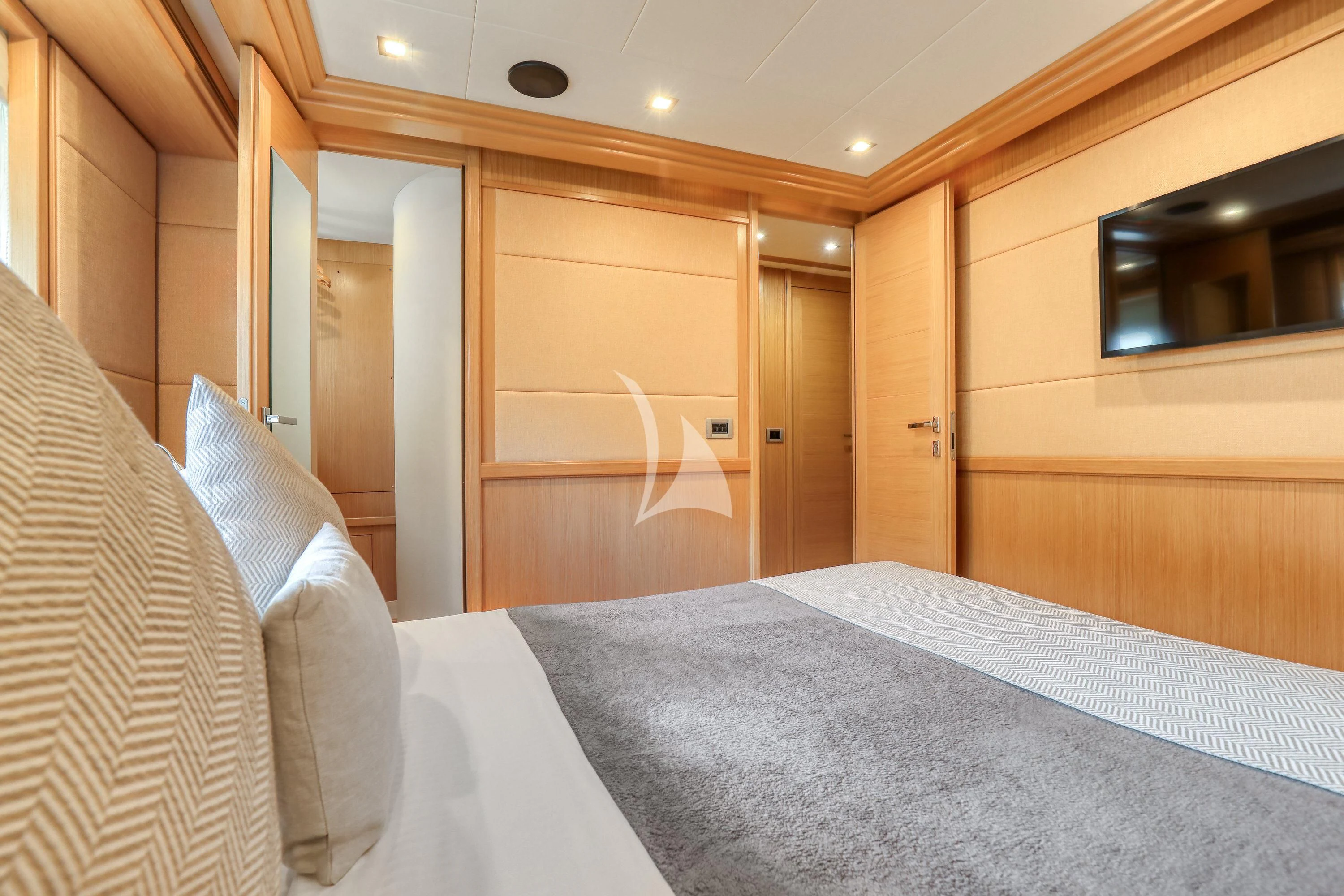 a room with a bed and a mirror aboard EOLIA Yacht for Sale