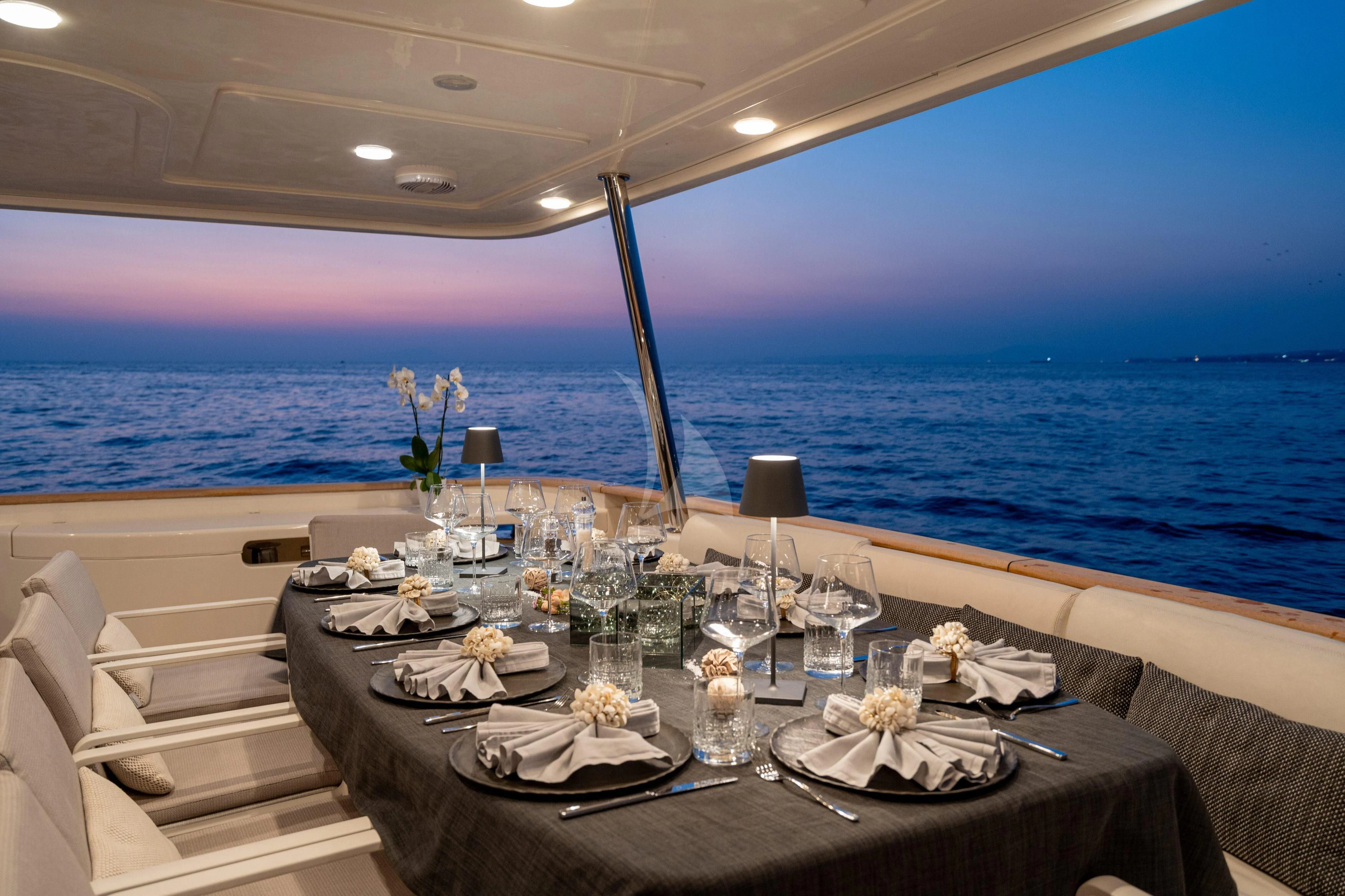 a table with plates and glasses on it aboard EOLIA Yacht for Sale