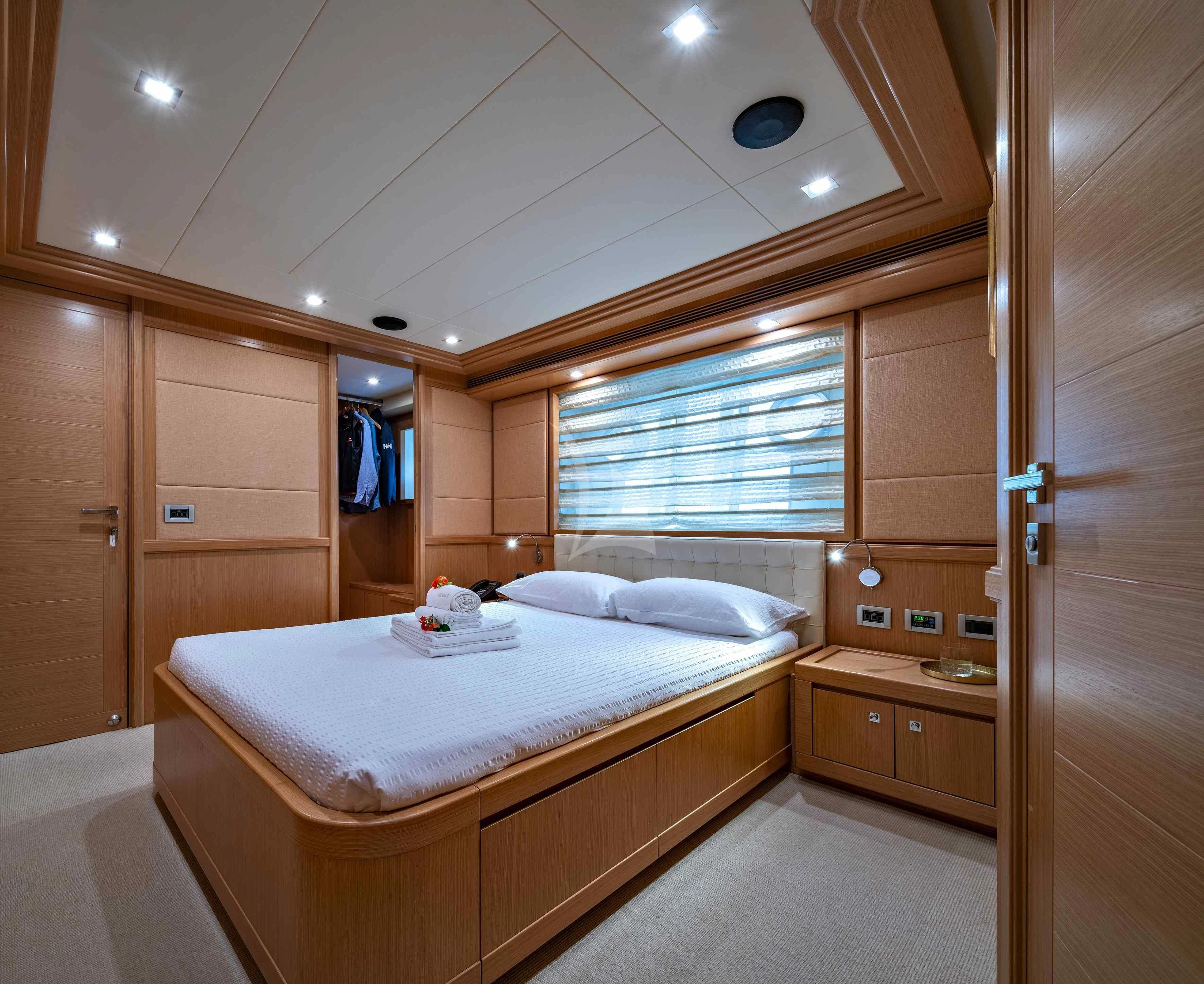 a bedroom with a bed and a closet aboard EOLIA Yacht for Sale
