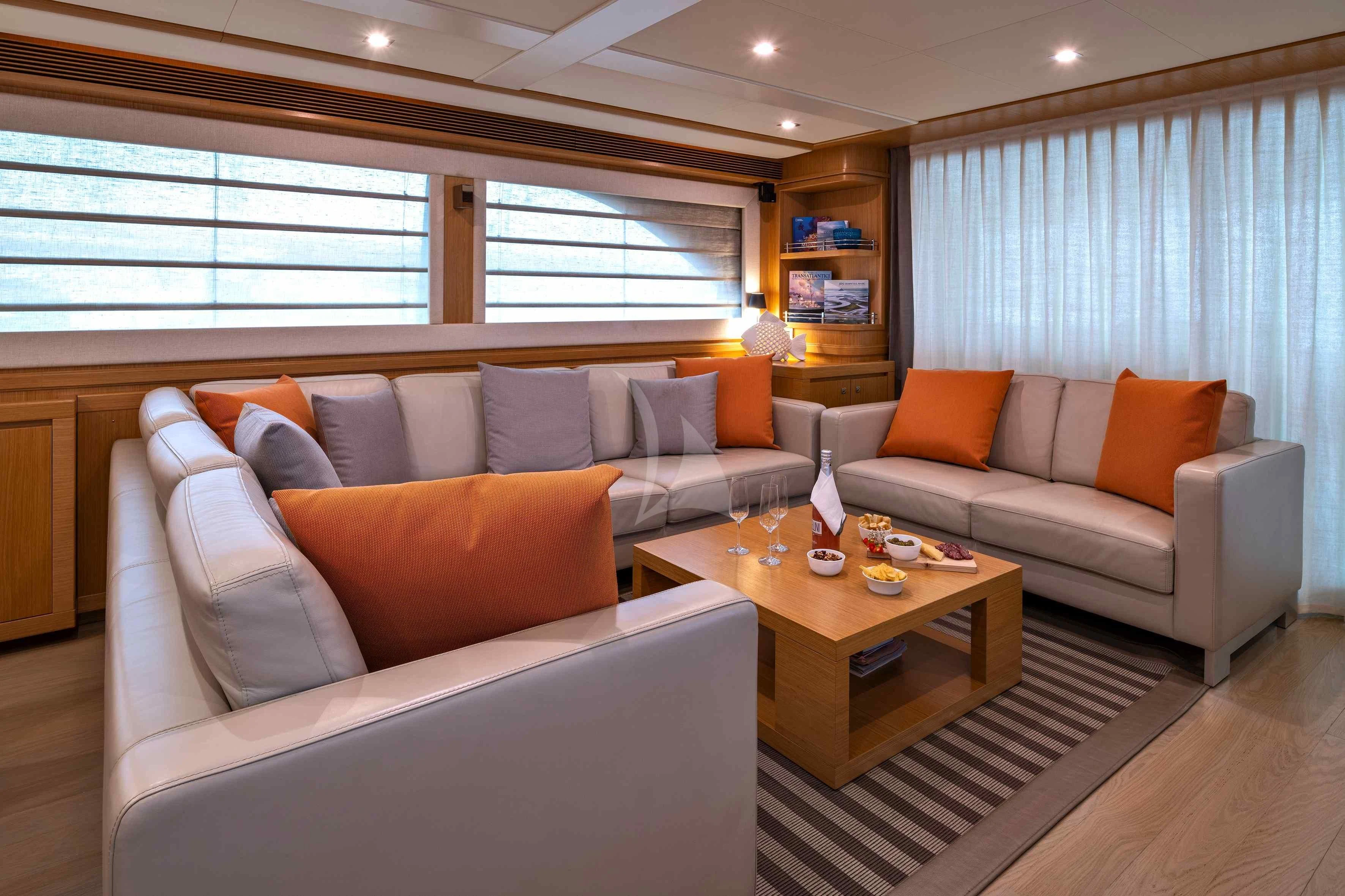 a living room with a couch and a coffee table aboard EOLIA Yacht for Sale