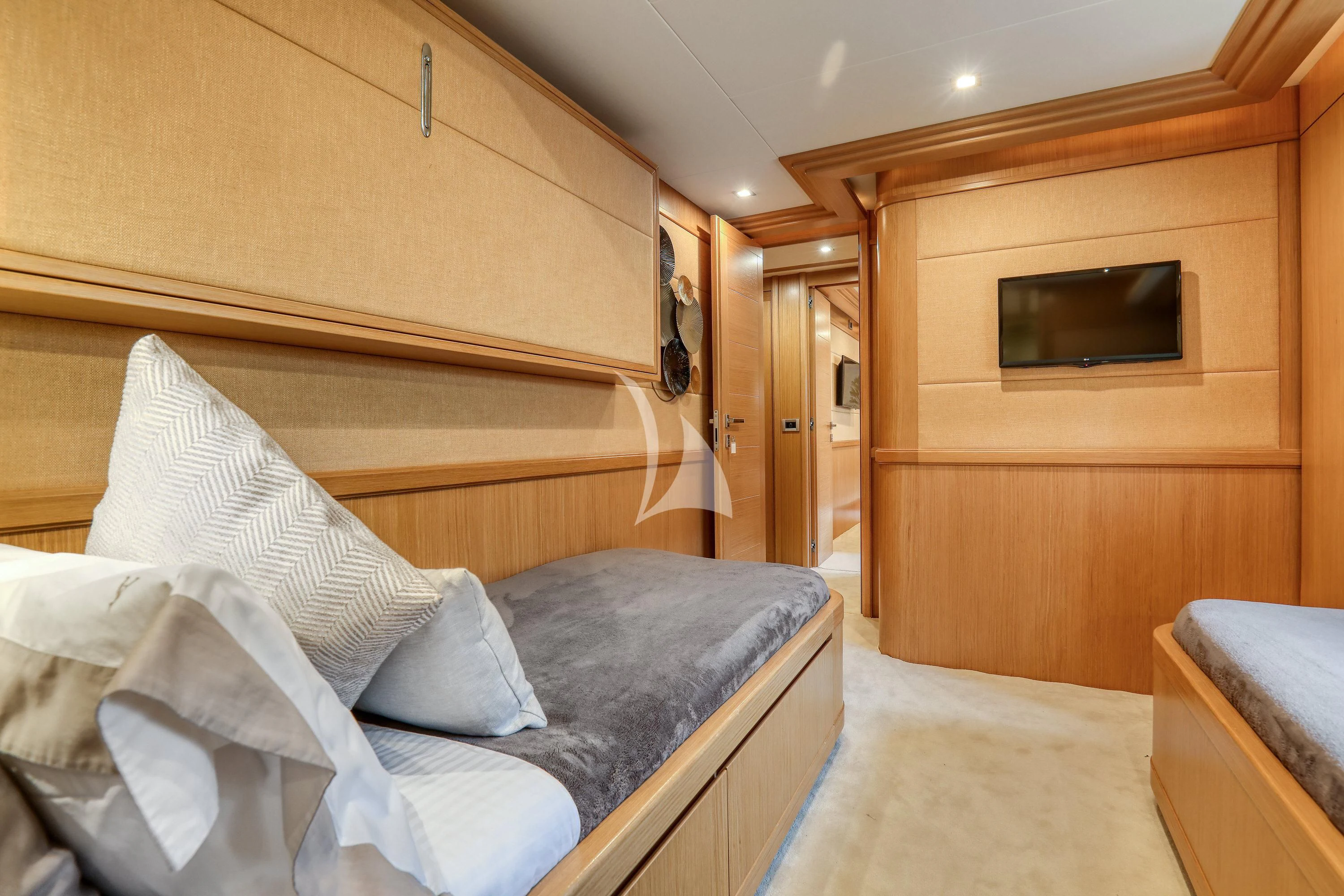 a bedroom with a bed and tv aboard EOLIA Yacht for Sale