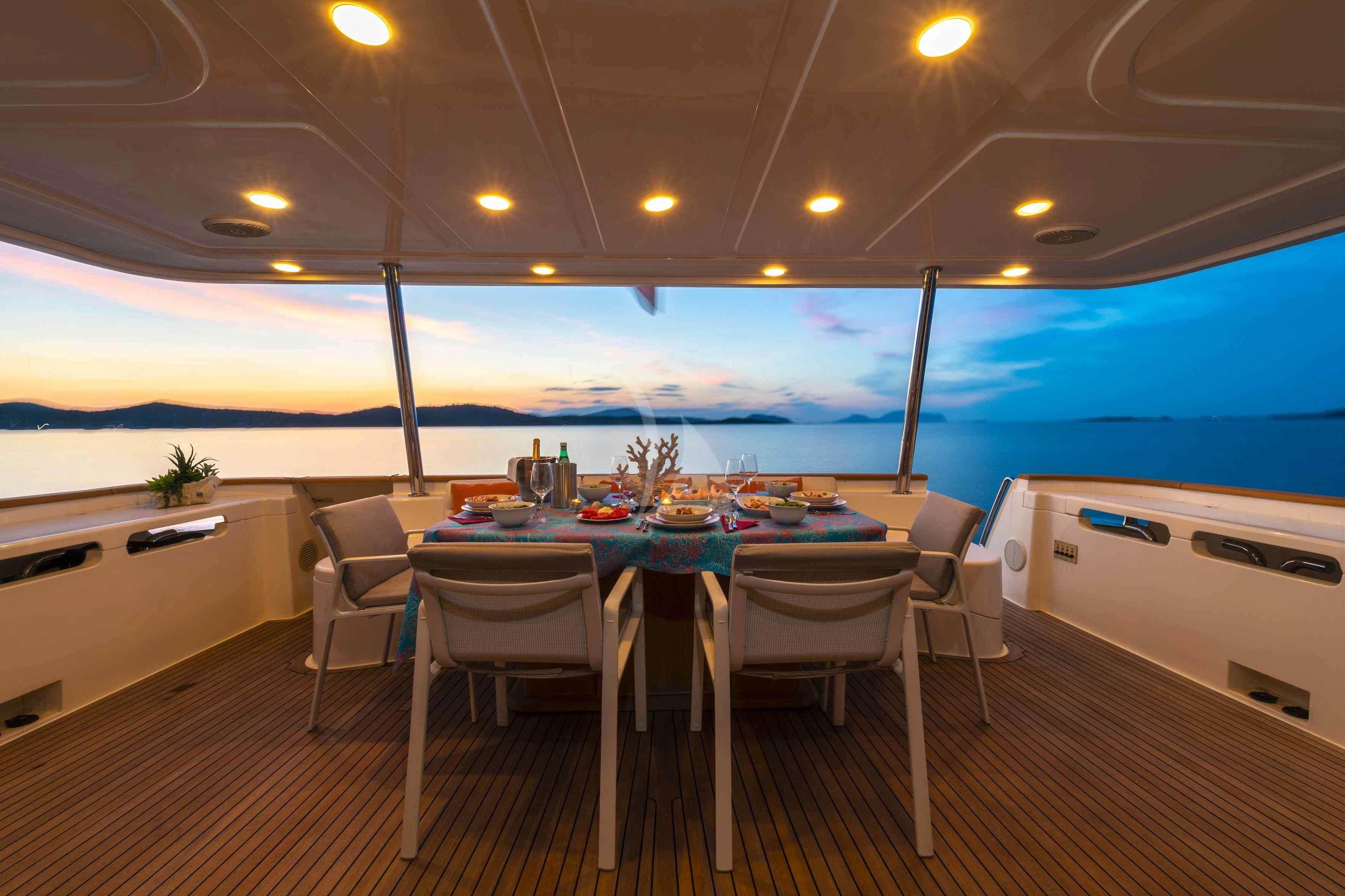a room with tables and chairs aboard EOLIA Yacht for Sale
