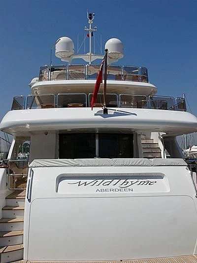 a white boat with a red stripe on the front aboard AURA Yacht for Sale