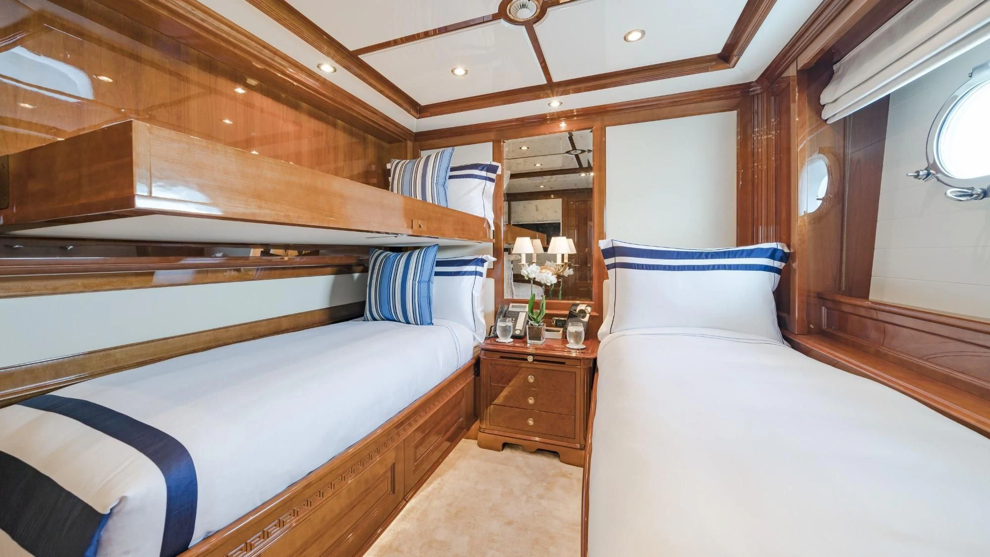 a room with a bed and a mirror aboard AURA Yacht for Sale