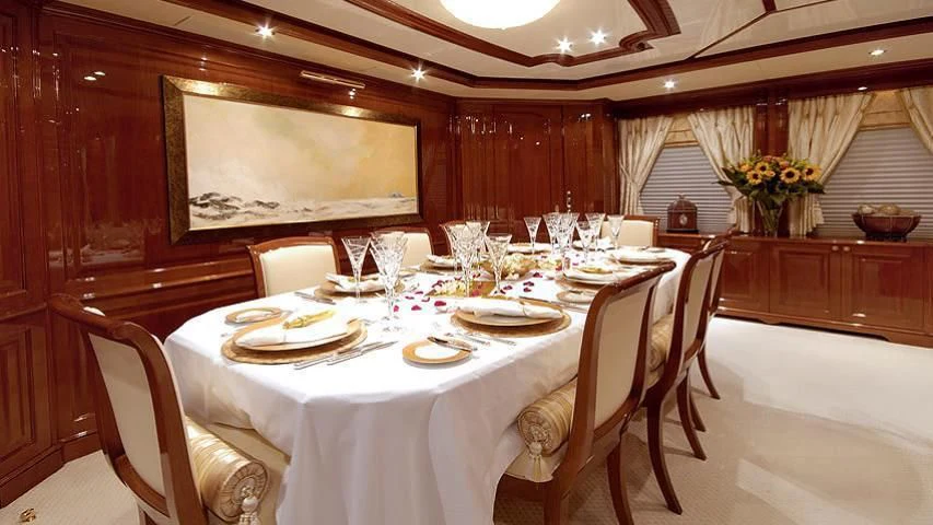 a dining table set for a dinner aboard AURA Yacht for Sale