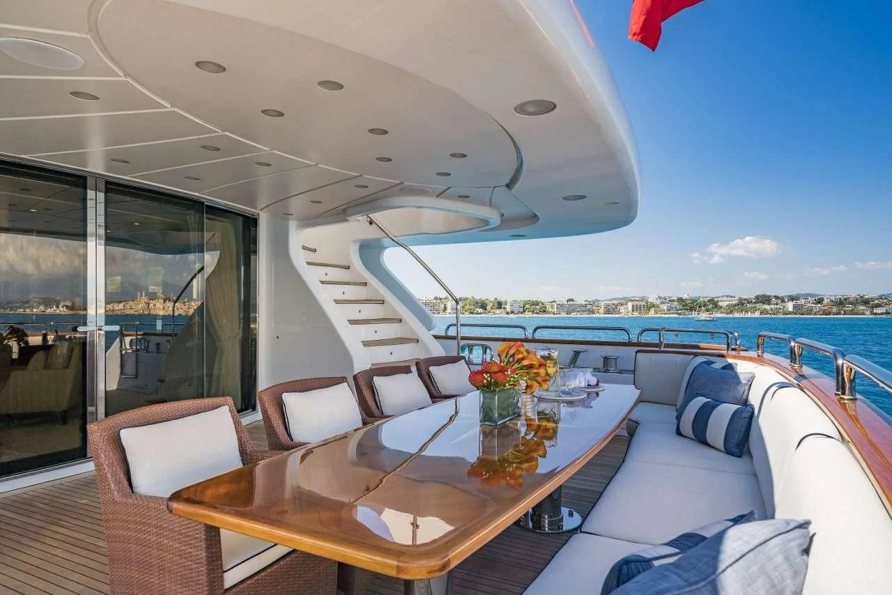 a table with chairs on it aboard AURA Yacht for Sale