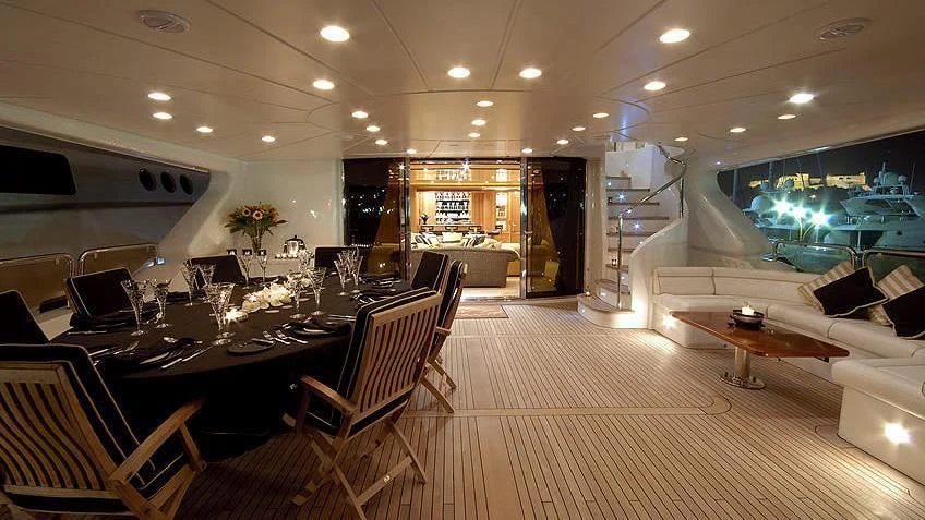 a large room with tables and chairs aboard AURA Yacht for Sale