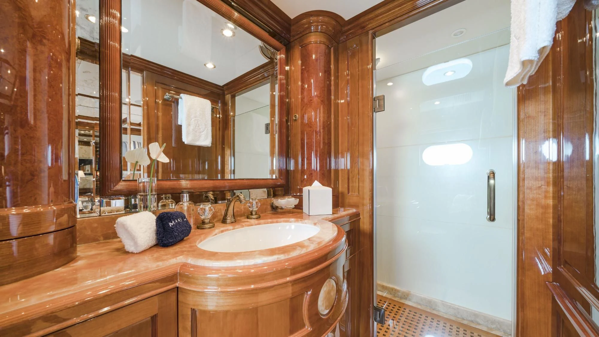 a bathroom with a sink and a mirror aboard AURA Yacht for Sale