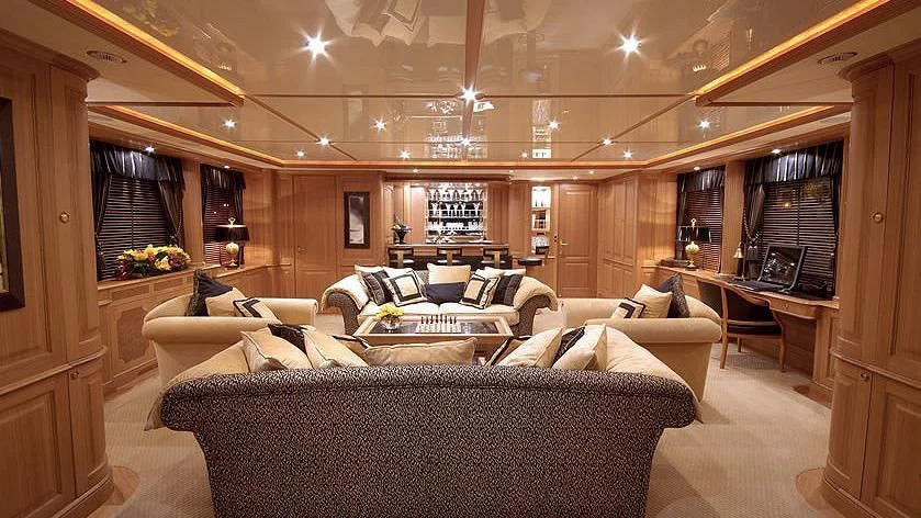 a living room with a couch and a table aboard AURA Yacht for Sale