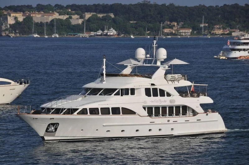 a white boat in the water aboard AURA Yacht for Sale
