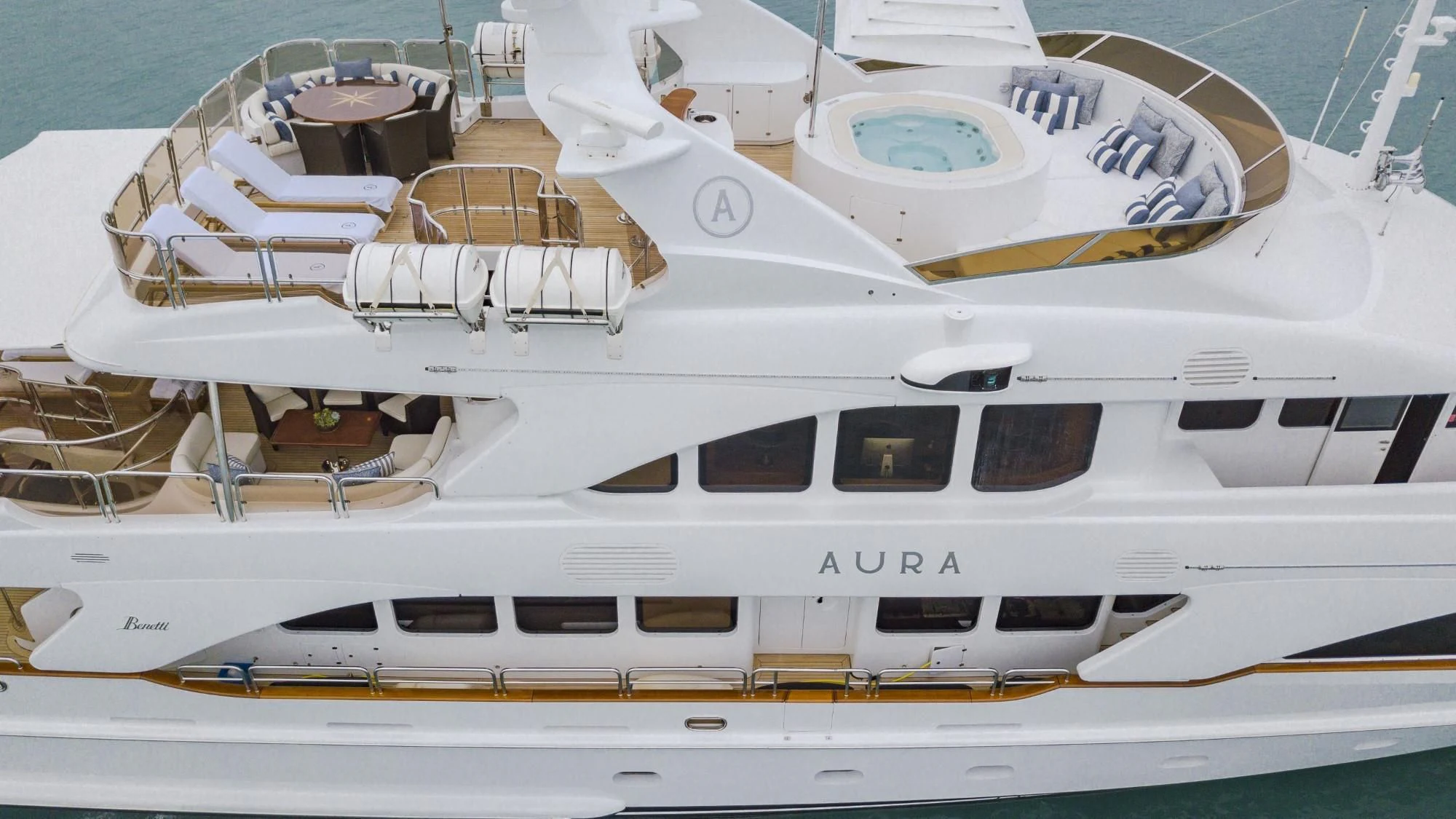 a white yacht with a gold trim aboard AURA Yacht for Sale
