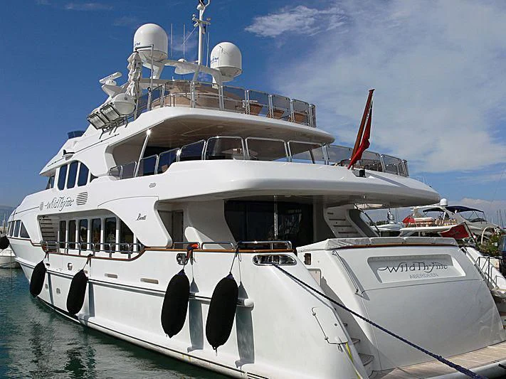 a white boat with a red crane on the front aboard AURA Yacht for Sale