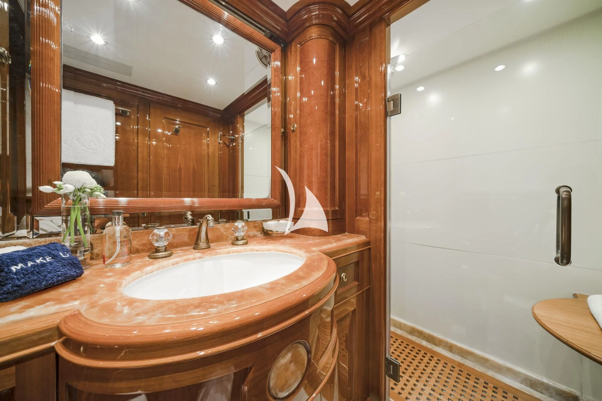 a bathroom with a large mirror aboard AURA Yacht for Sale