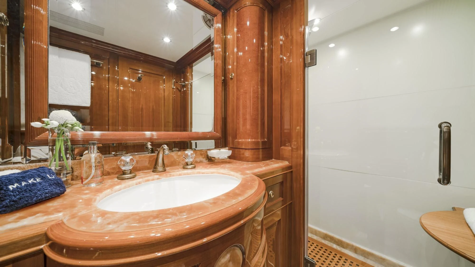 a bathroom with a sink and mirror aboard AURA Yacht for Sale