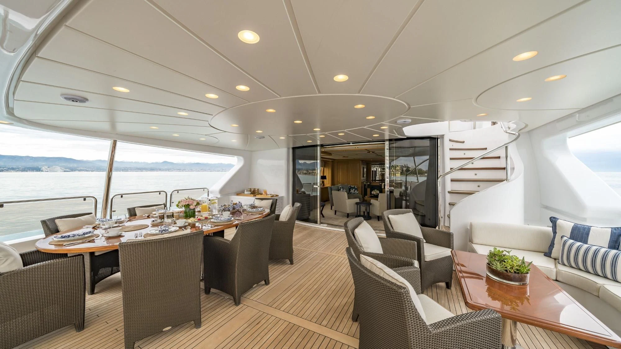 a large room with a table and chairs and a large window aboard AURA Yacht for Sale