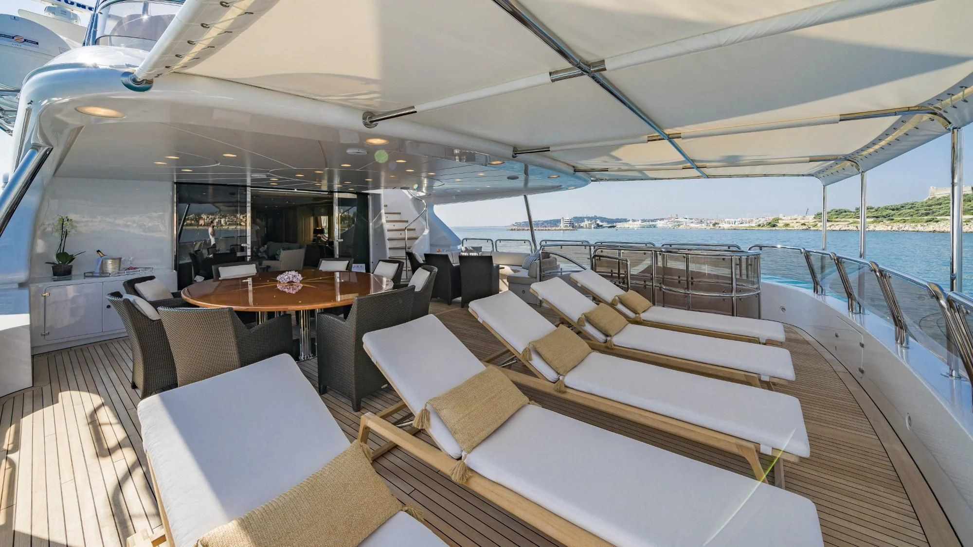 a boat with tables and chairs aboard AURA Yacht for Sale