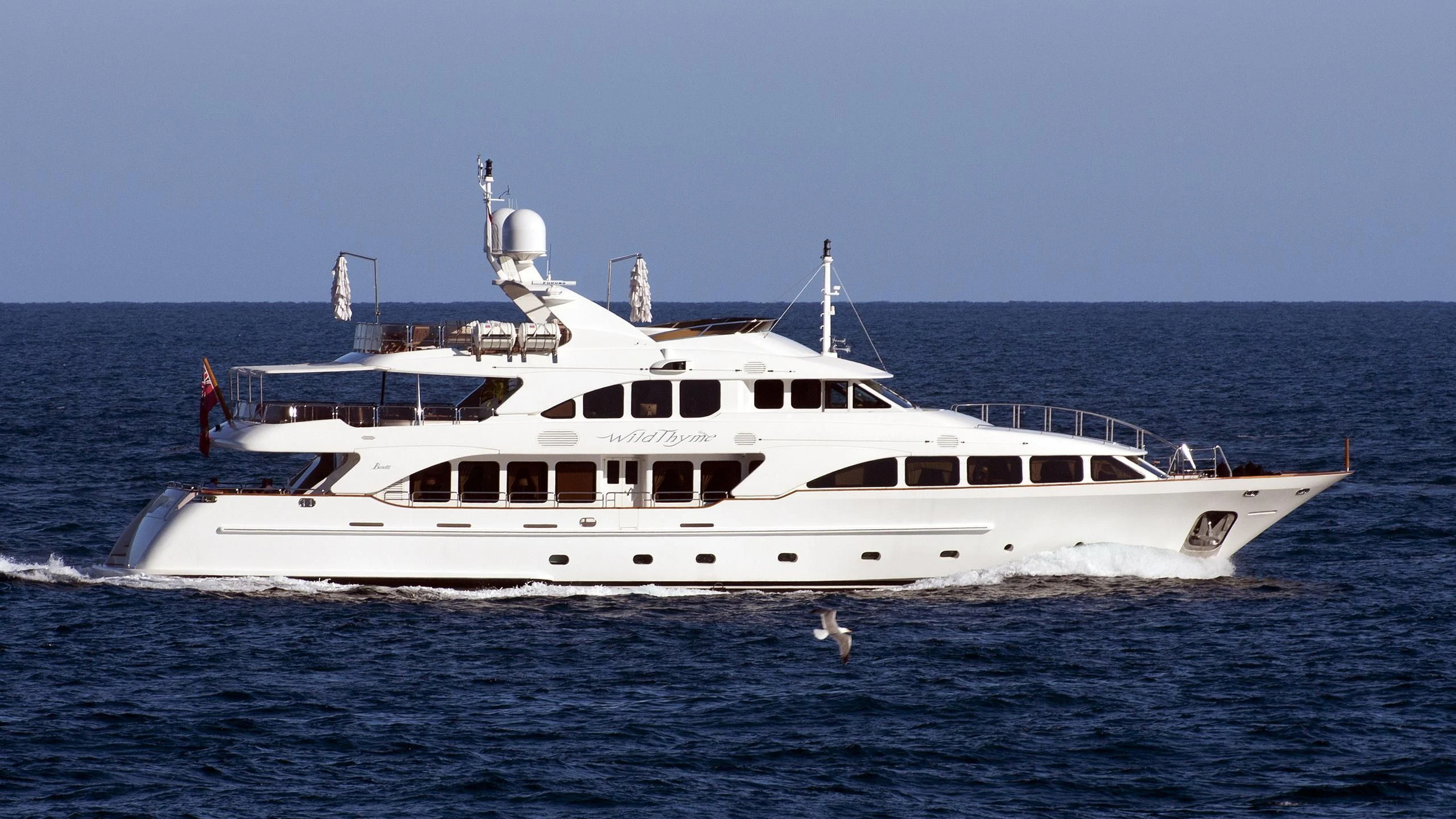 a large white boat in the water aboard AURA Yacht for Sale