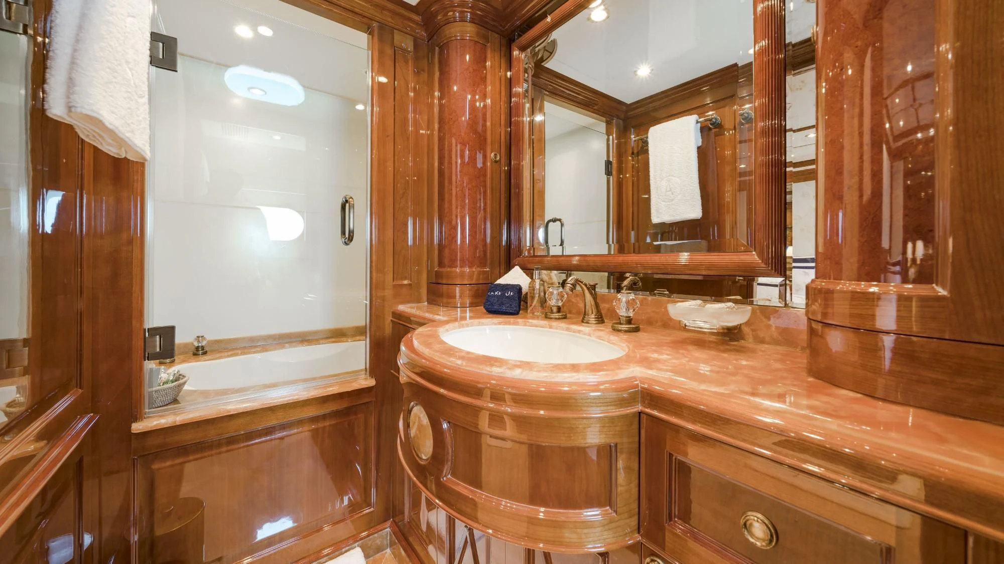 a bathroom with a sink and a mirror aboard AURA Yacht for Sale
