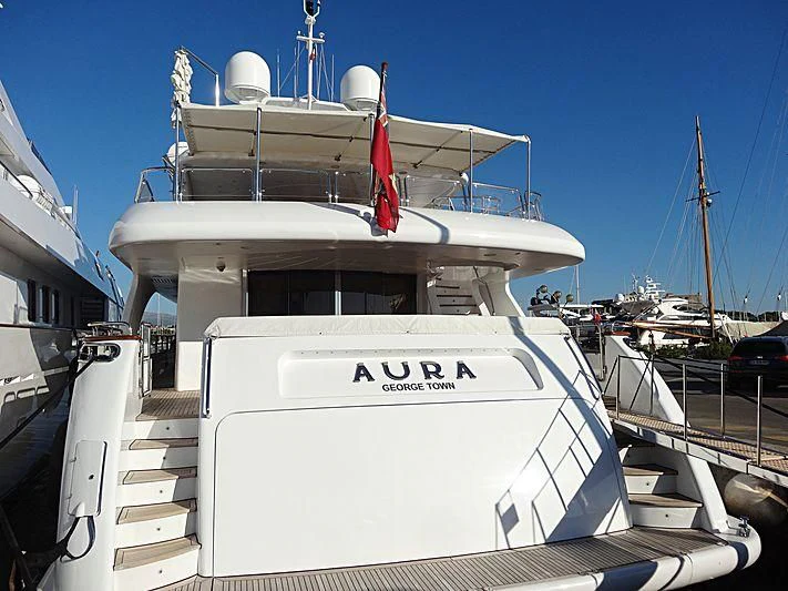 a boat docked at a pier aboard AURA Yacht for Sale