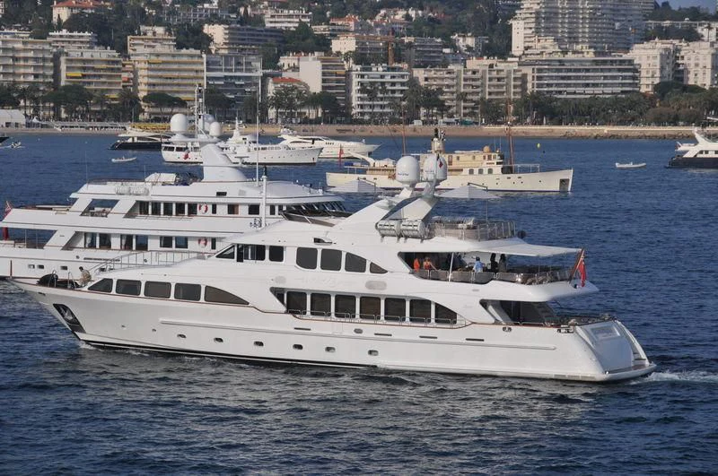 a large white boat in the water aboard AURA Yacht for Sale
