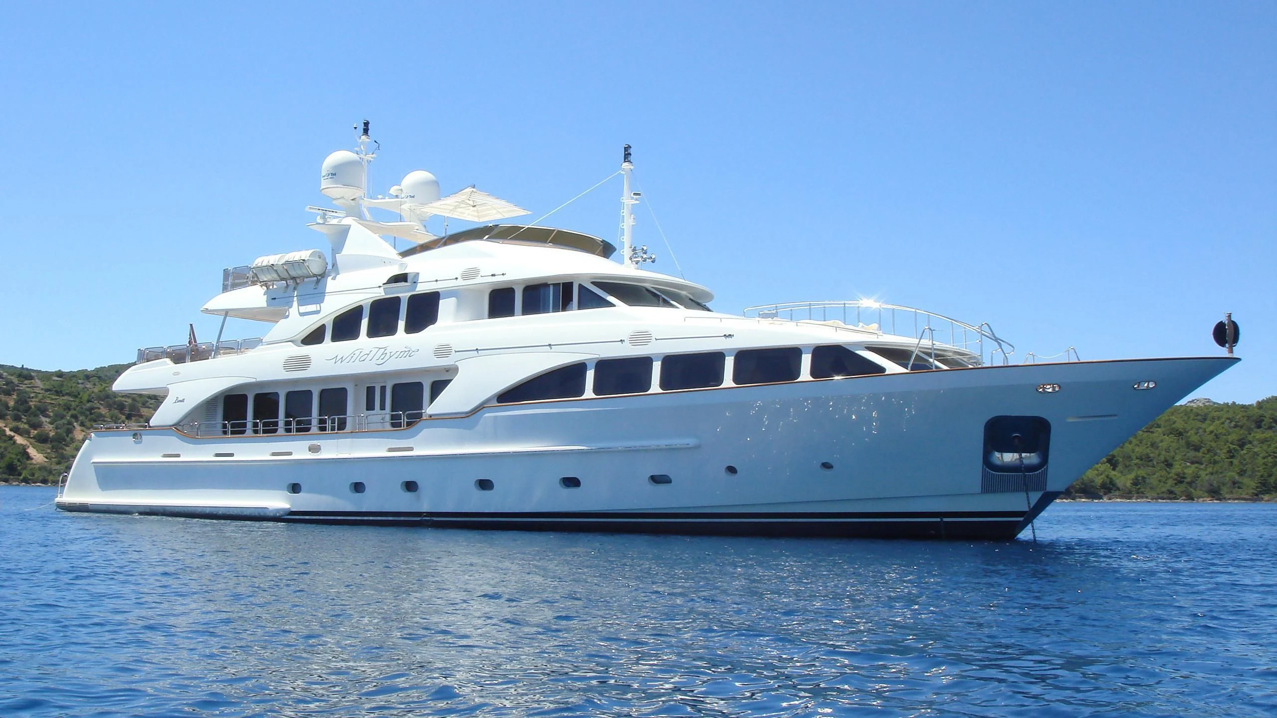 a large white boat on the water aboard AURA Yacht for Sale