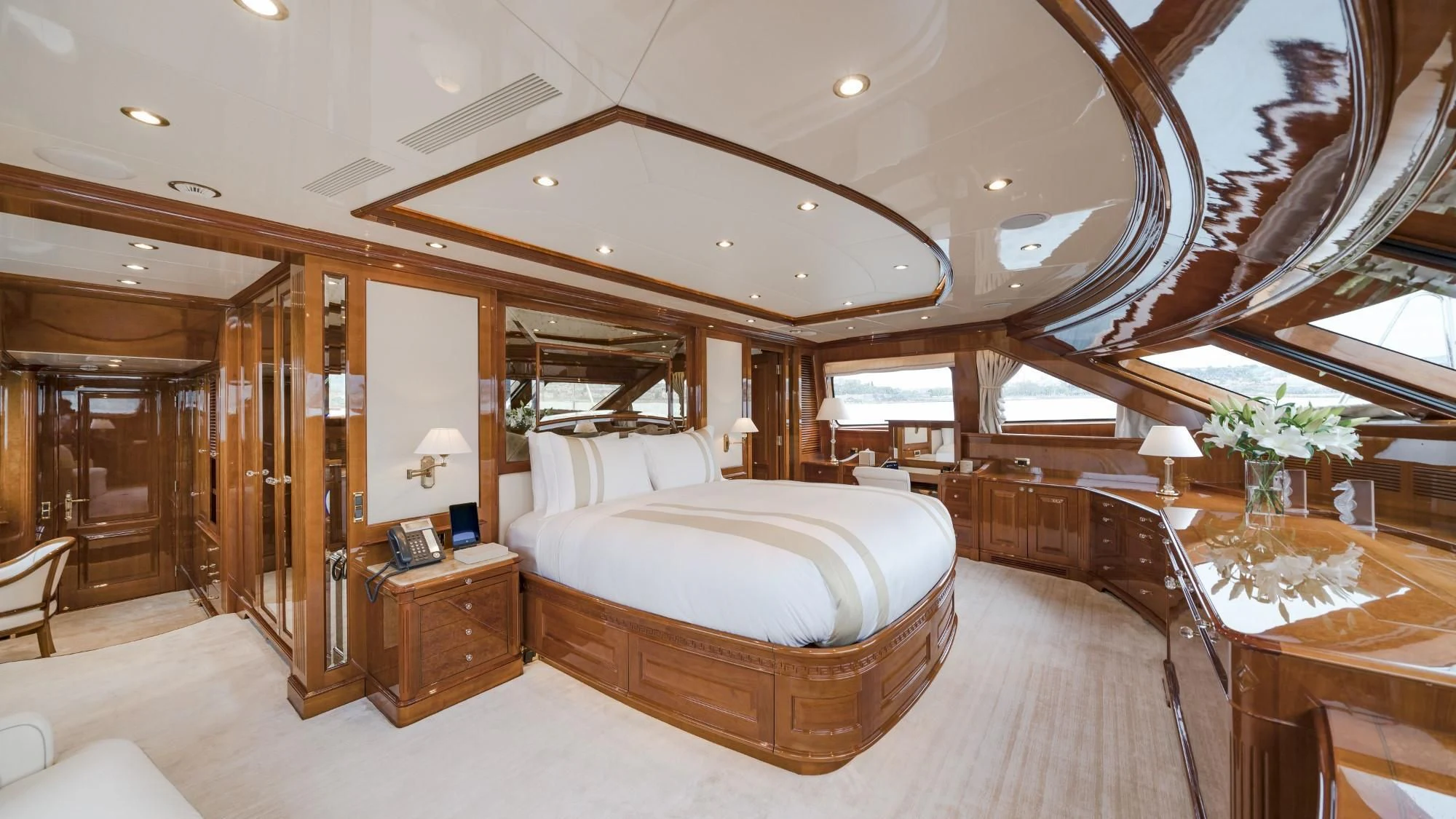 a large bedroom with a large bed aboard AURA Yacht for Sale