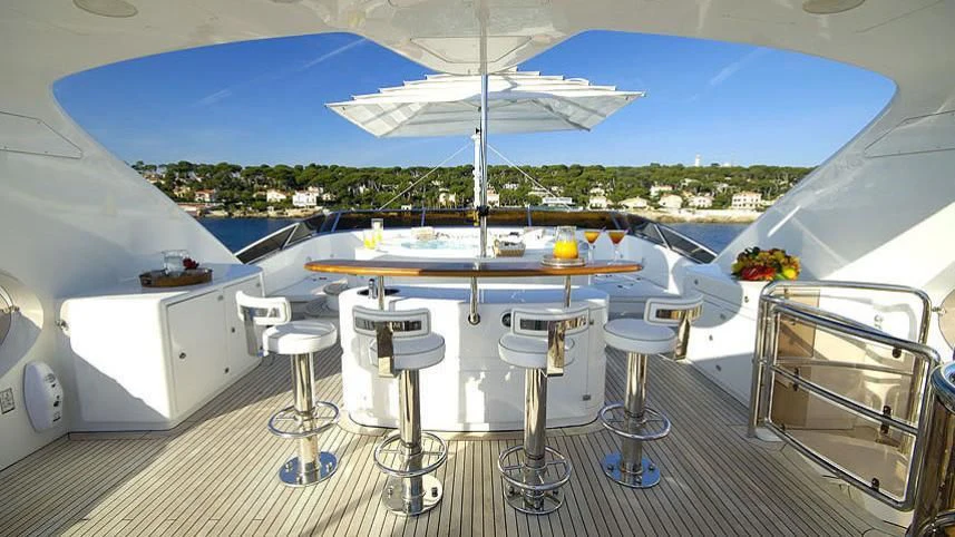 a room with a table and chairs aboard AURA Yacht for Sale