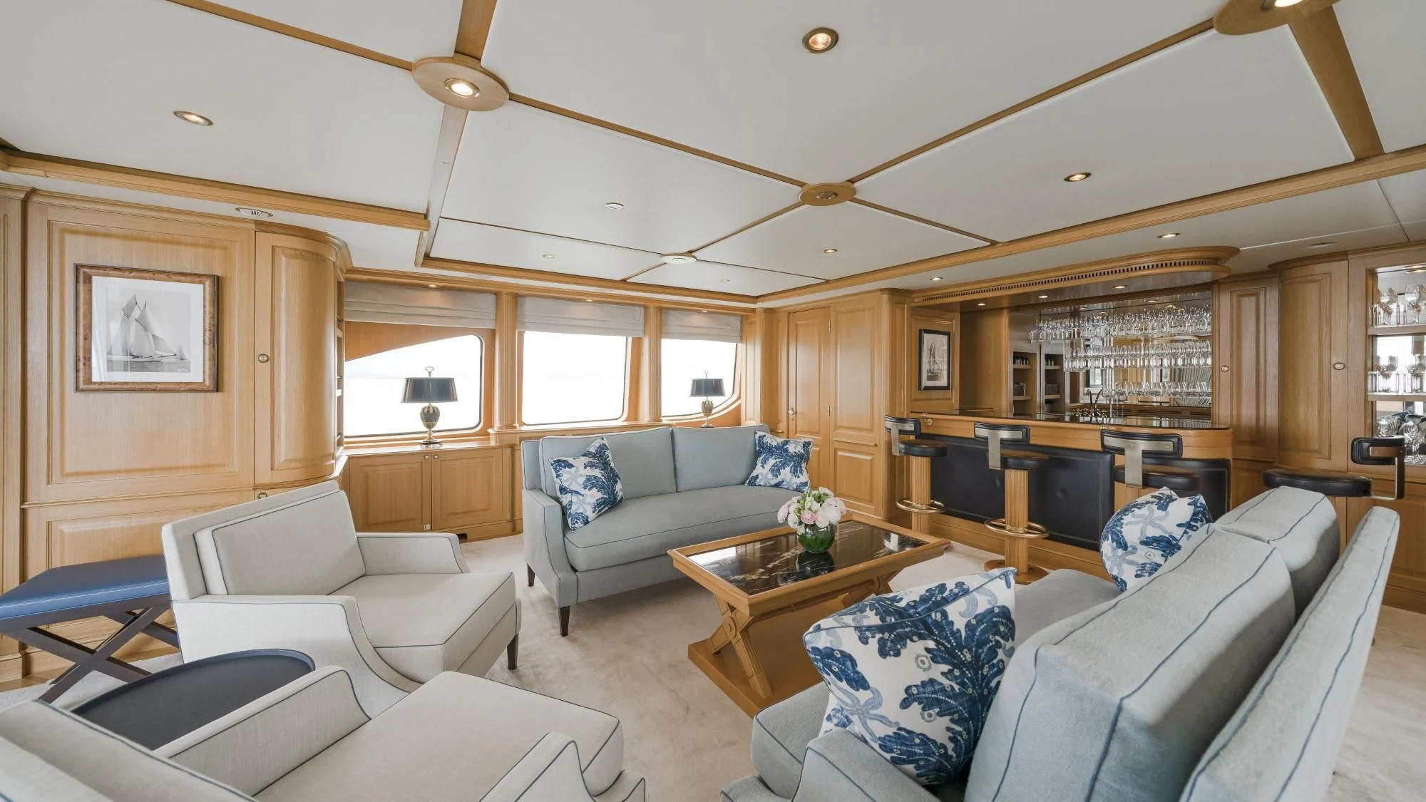 a living room with a couch and a coffee table aboard AURA Yacht for Sale