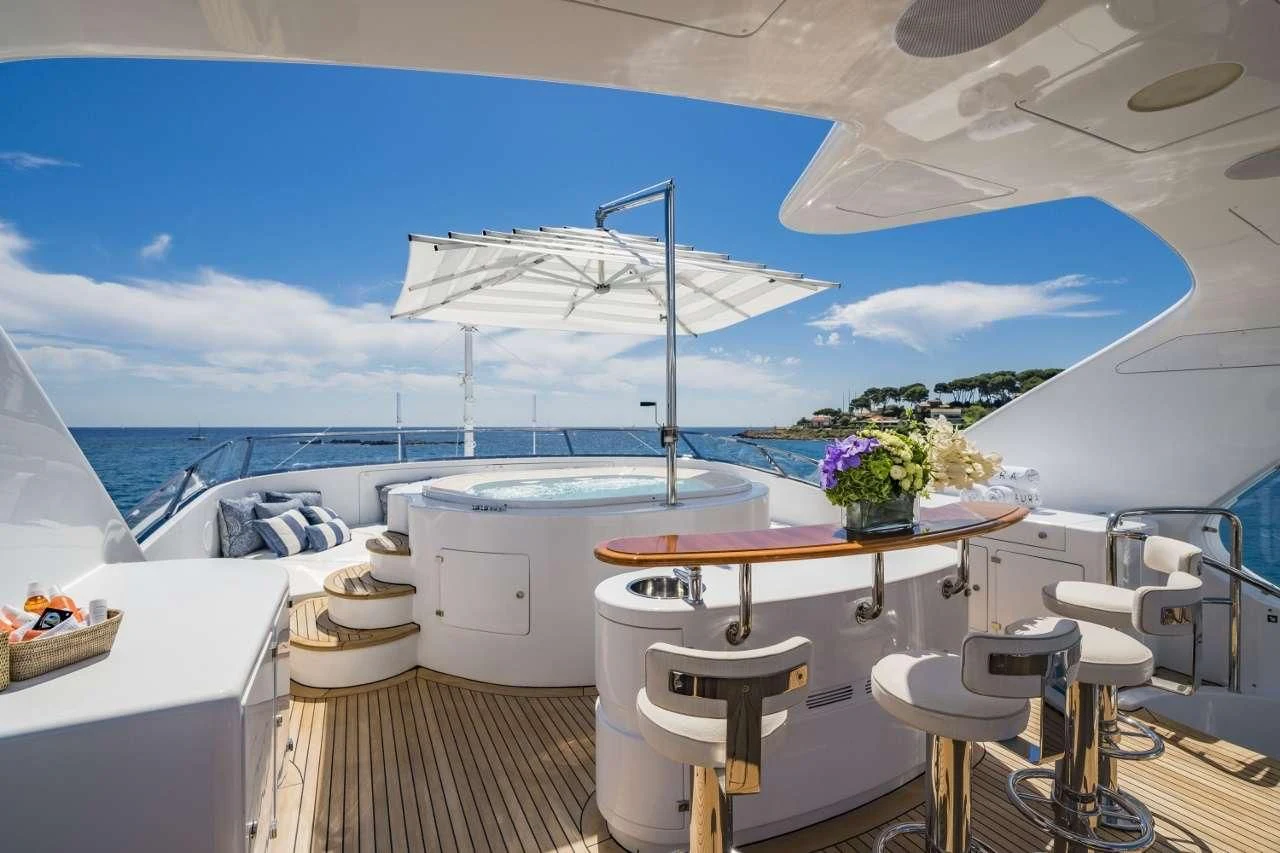 a room with a table and chairs aboard AURA Yacht for Sale