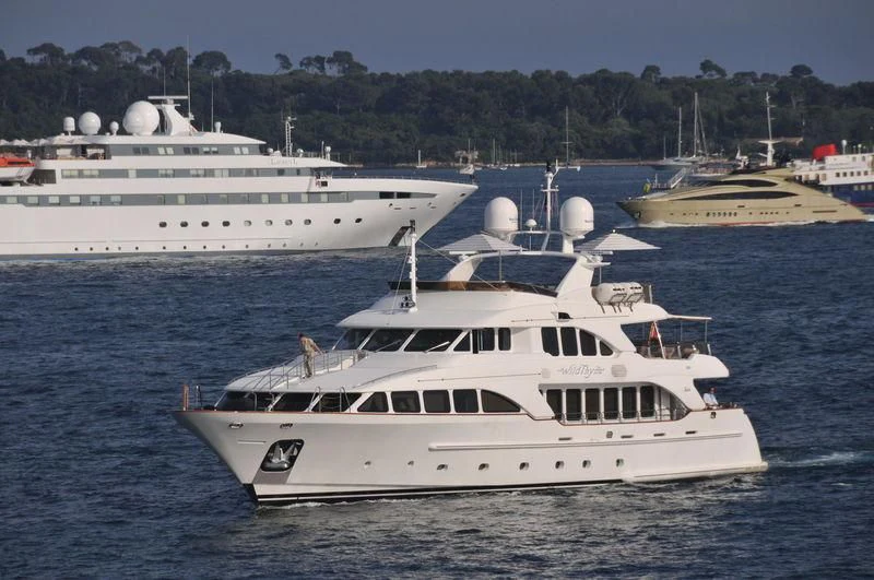 a couple of large white boats in the water aboard AURA Yacht for Sale