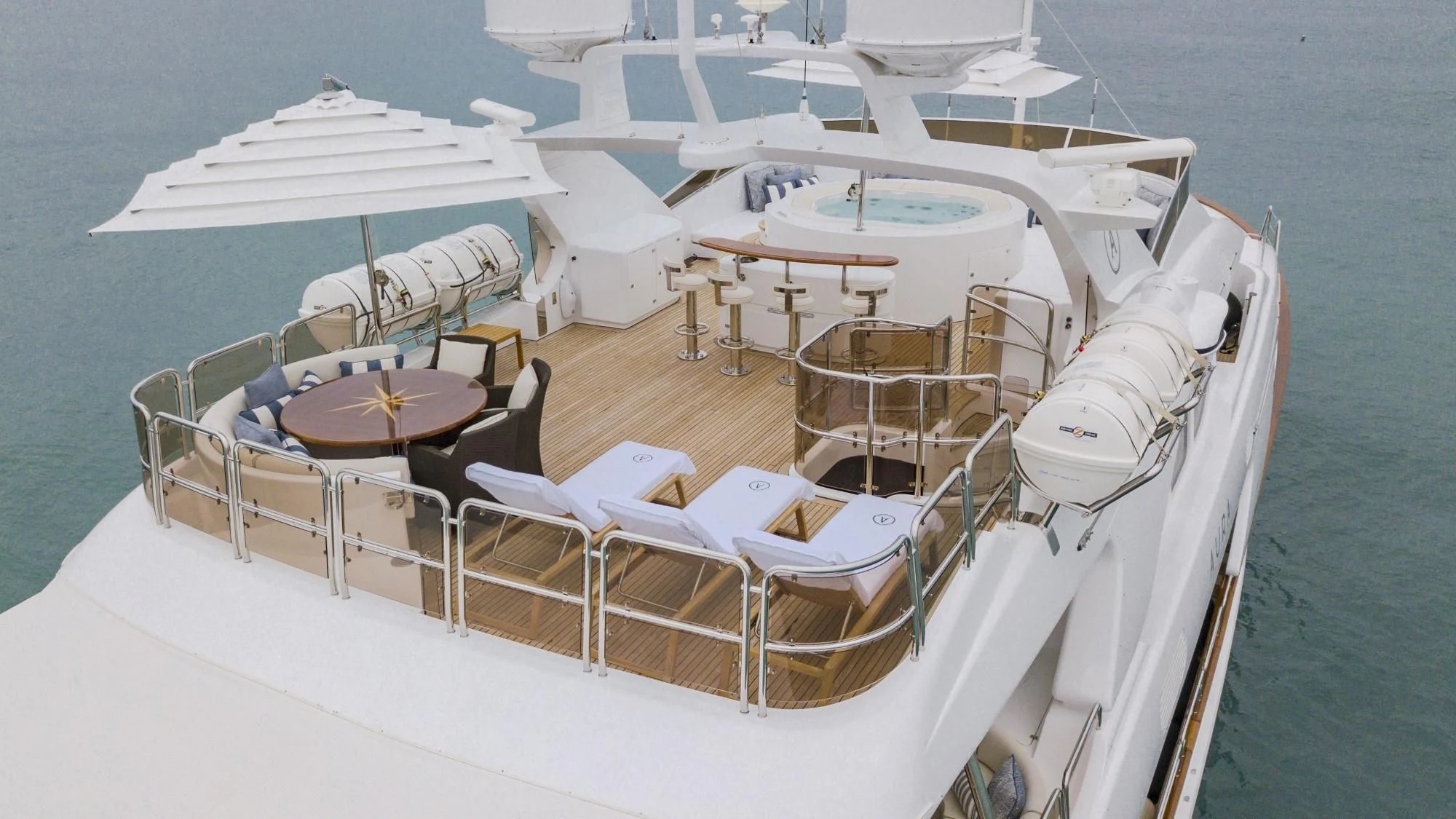a boat with white chairs on it aboard AURA Yacht for Sale