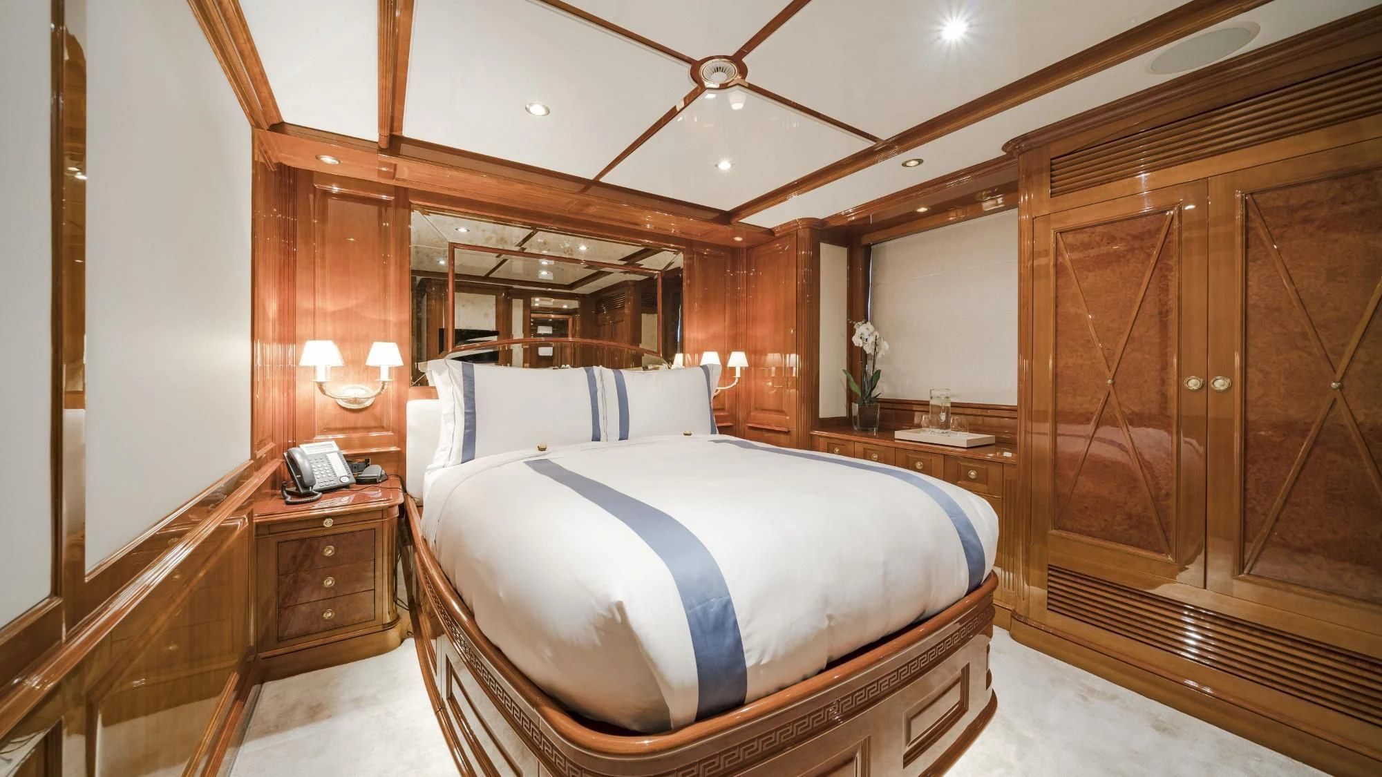 a large bedroom with a bed aboard AURA Yacht for Sale