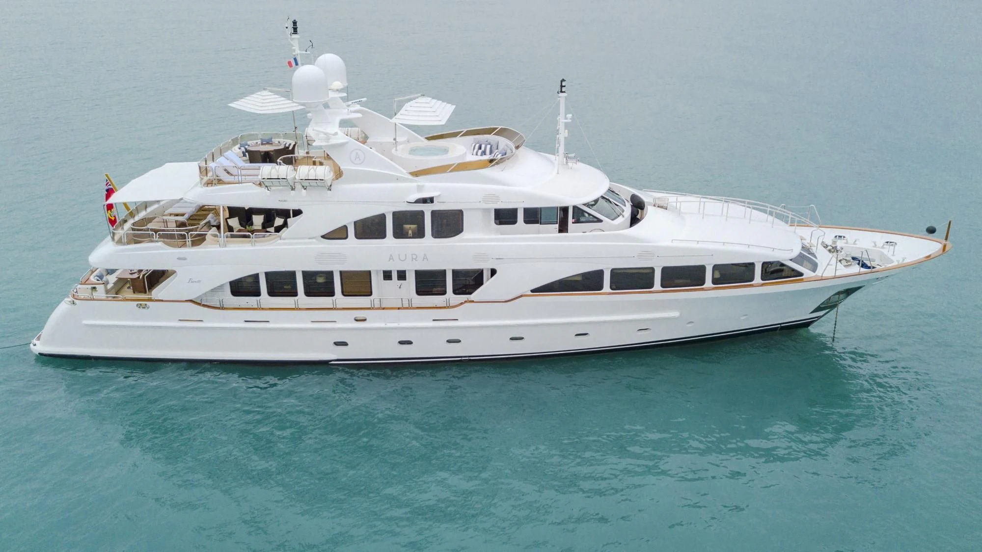a white yacht in the water aboard AURA Yacht for Sale