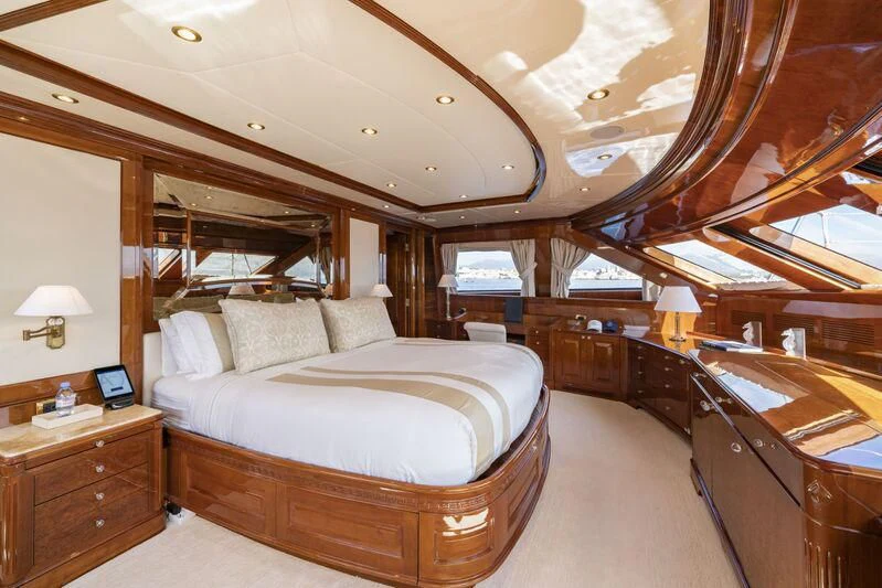 a bedroom with a bed and a piano aboard AURA Yacht for Sale