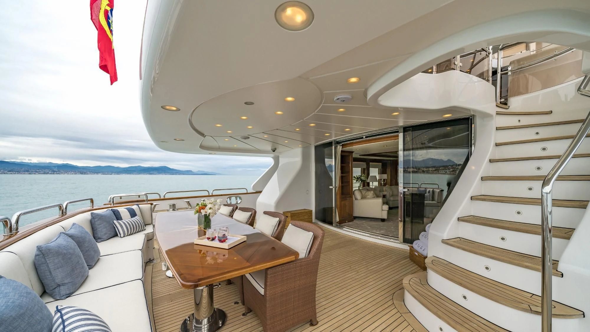 a boat with a table and chairs aboard AURA Yacht for Sale